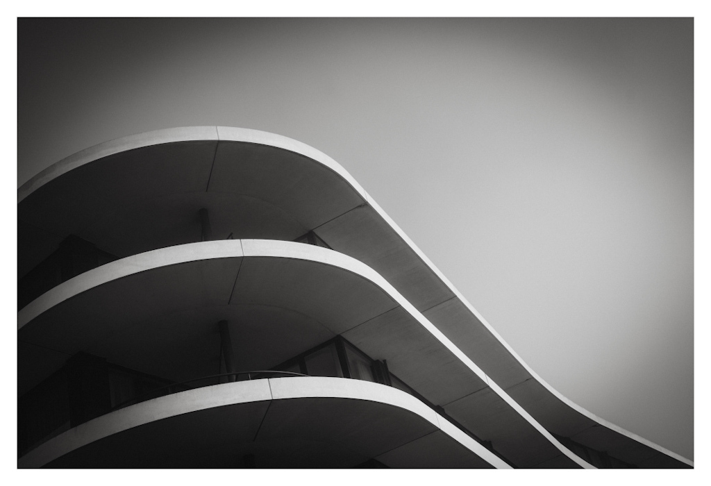 Wave shapes in the contour of a building, shown in black and white. 