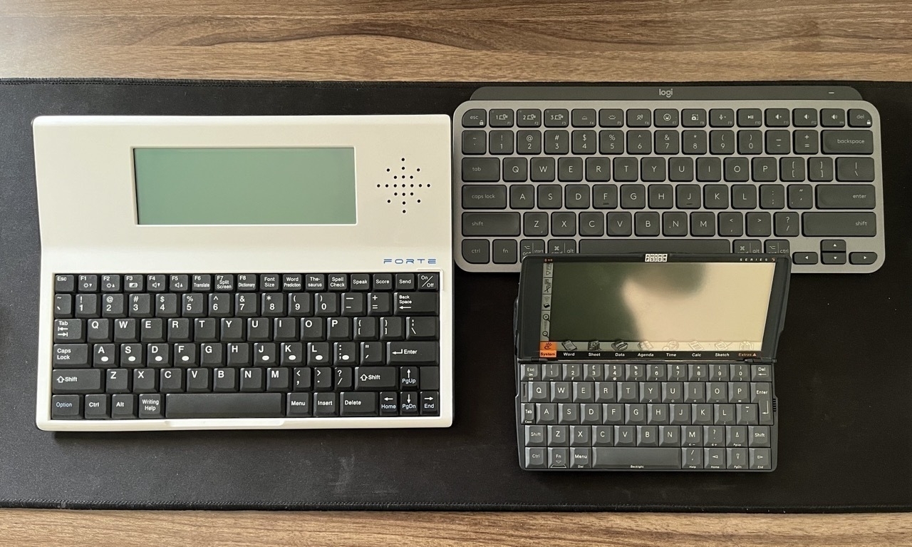 The Writer Forte word processor next to the Logitech MX Keys Mini and the PSION Series 5 PDA