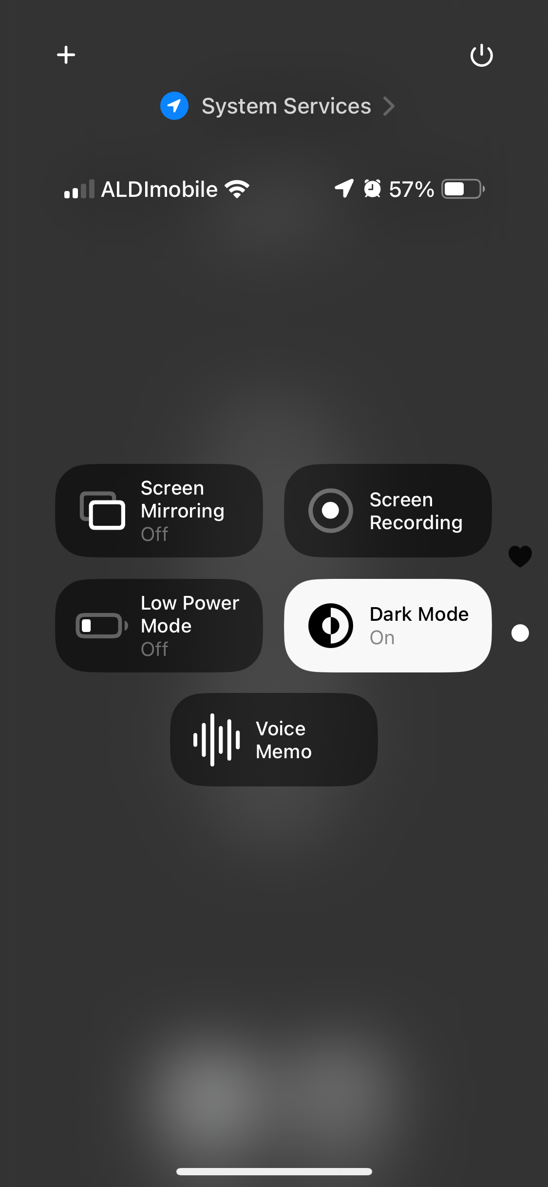 A smartphone control center interface showing various settings. The top row displays Wi-Fi, mobile network labeled as ALDImobile, location services, and battery percentage at 57%. Below, options are displayed for Screen Mirroring (Off), Screen Recording, Low Power Mode (Off), Dark Mode (On), and Voice Memo. The background is dark, indicating the dark mode is active.