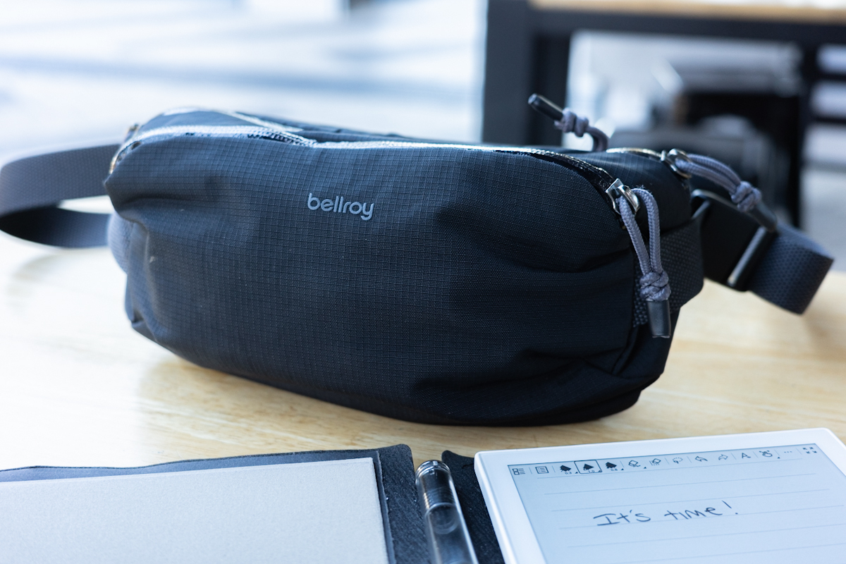 The Bellroy Venture bag on a table next to a notepad with the words 'It's Time' written