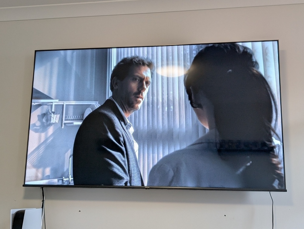 Two people are engaged in a conversation on a screen displaying a scene from a show or movie.