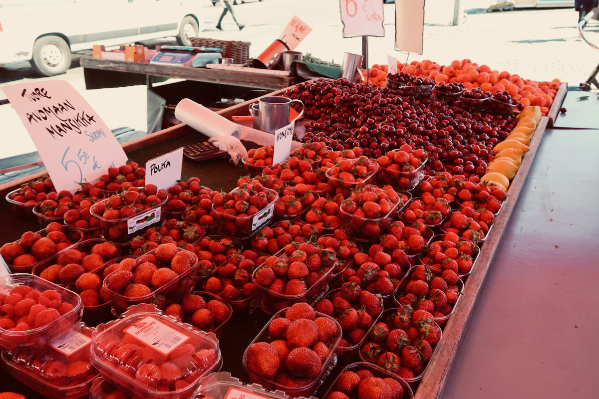 strawberries for sale outside on a market stall