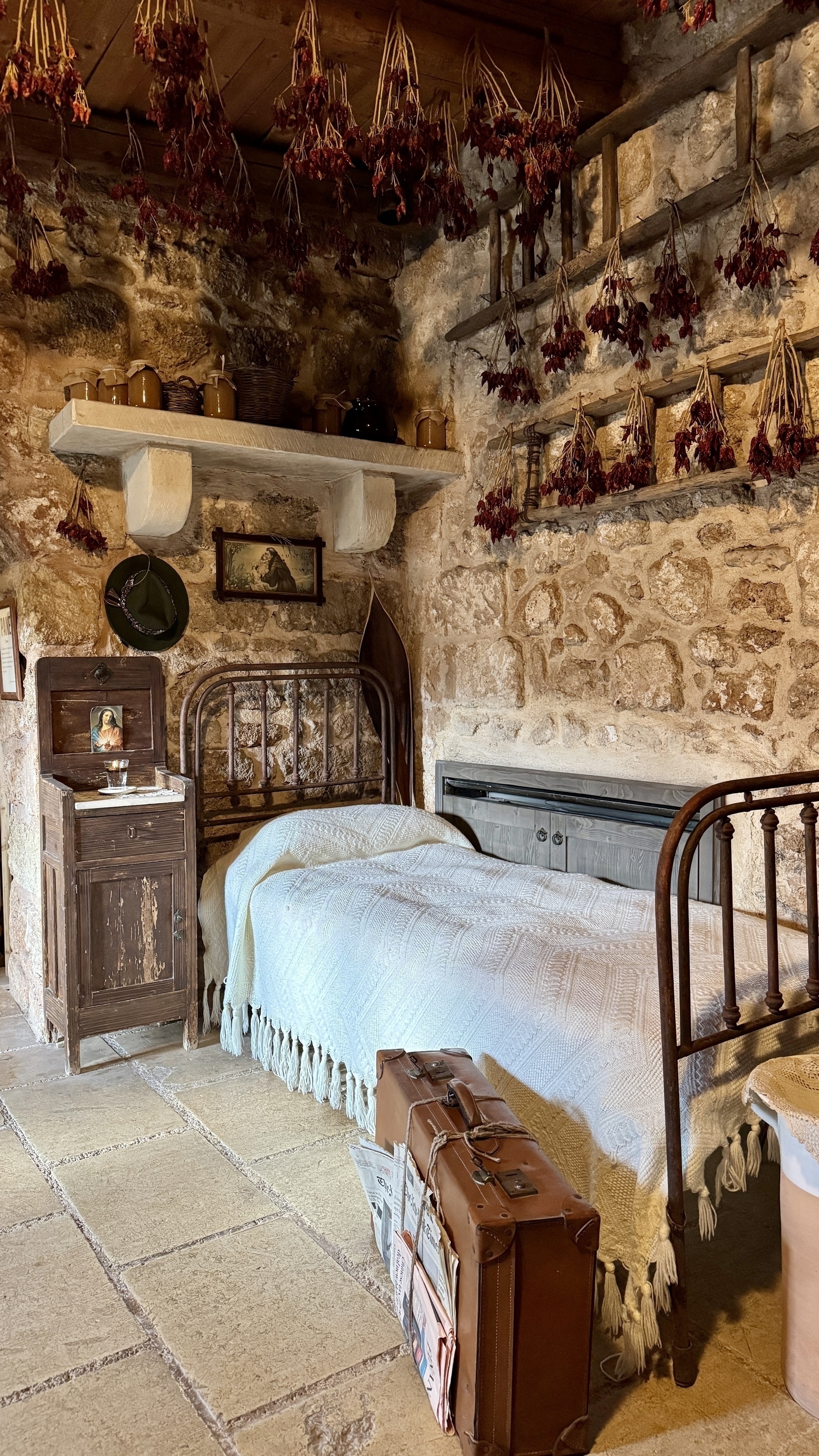 A single bedroom in a southern Italian masseria decorated as though it was the start of the 20th century.