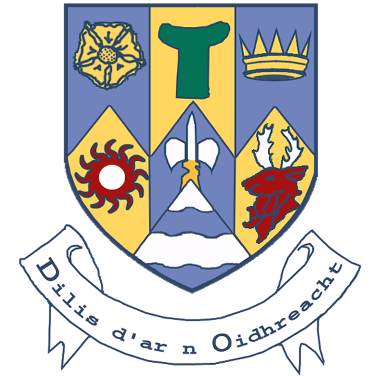 A coat of arms featuring symbolic elements such as a rose, an antlered animal, a crown, a sun, and a letter "T" with a banner below displaying Irish text.