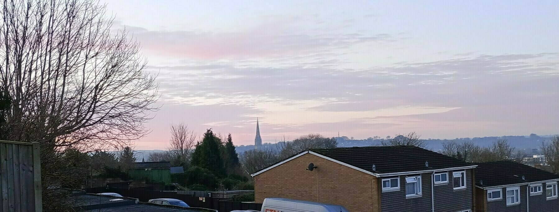 view over Salisbury with pale blue pink sky