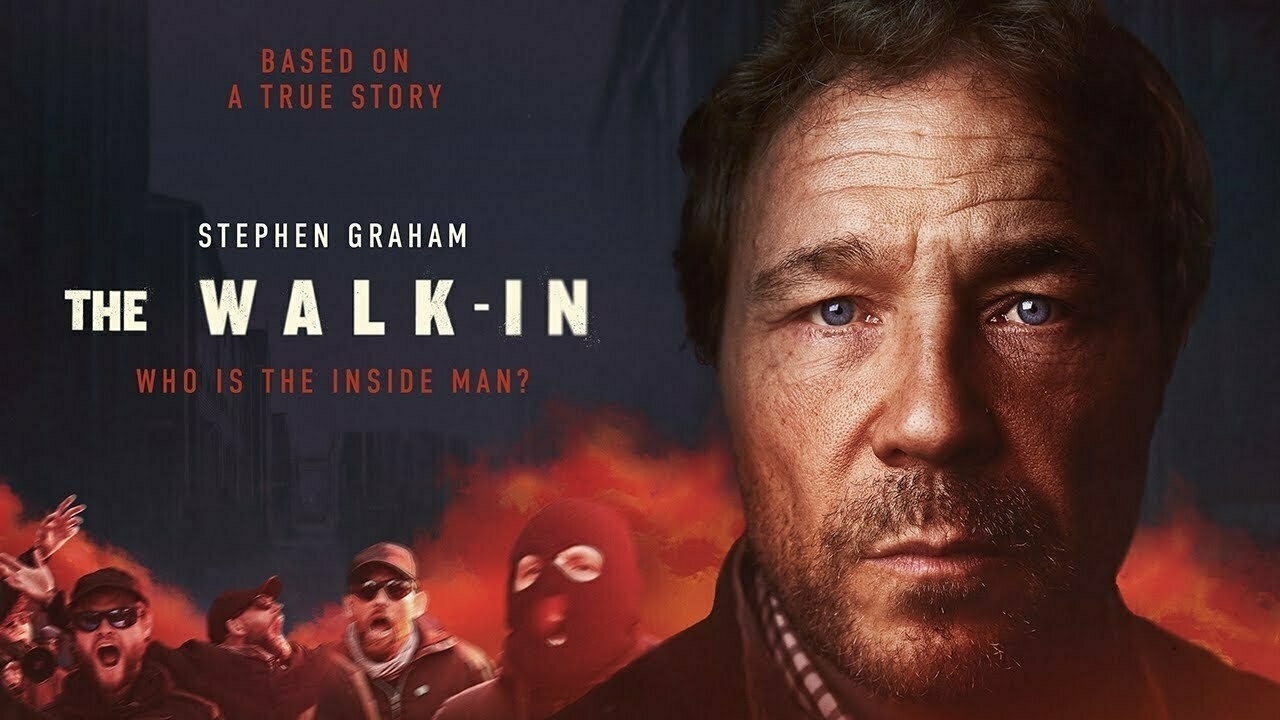 A promotional poster featuring a man’s face prominently on the right and a group of people, some in masks, on the left with text indicating it's based on a true story titled The Walk-In