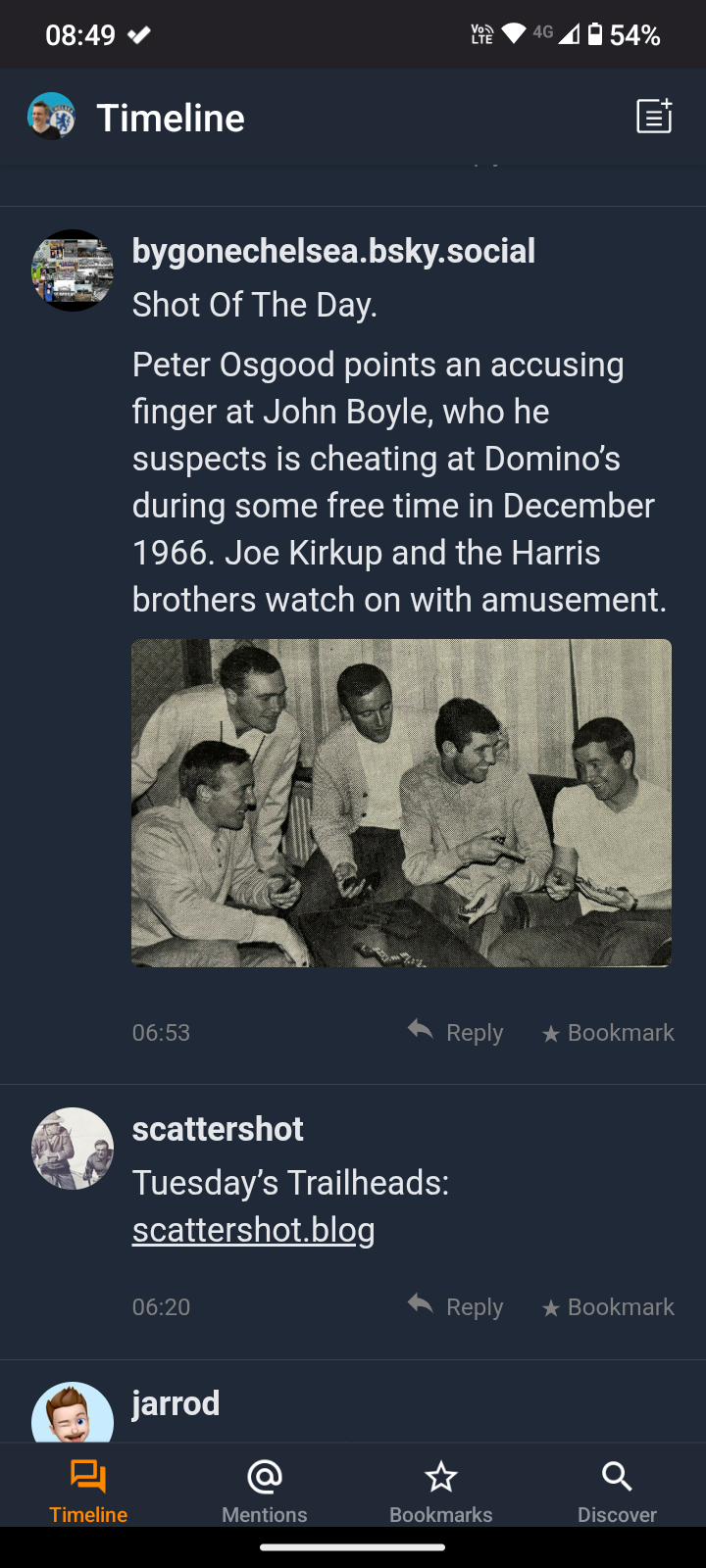 A group of men, including Peter Osgood pointing at John Boyle, are gathered around playing Domino's in December 1966, while Joe Kirkup and the Harris brothers watch and smile.