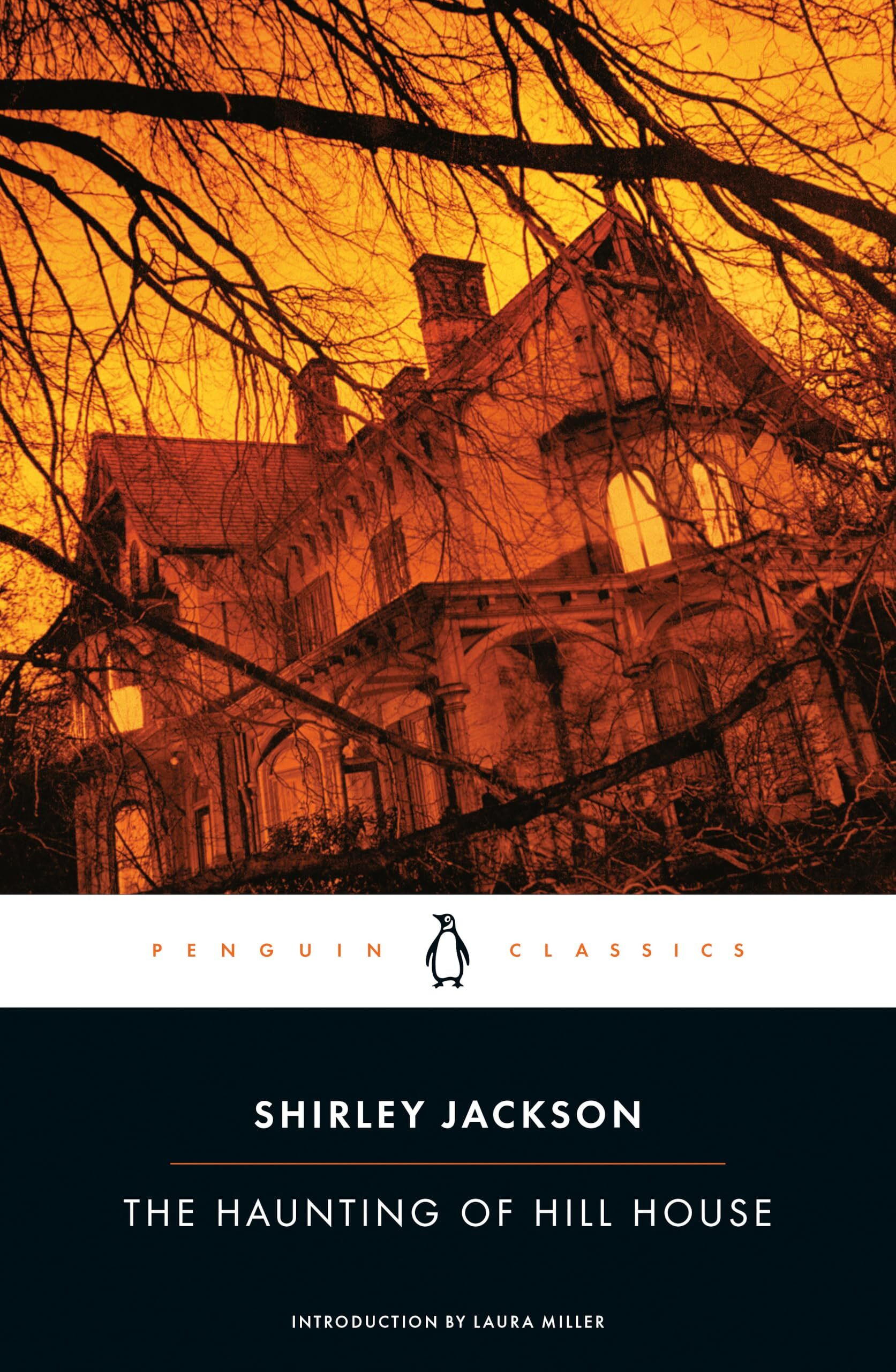 A dark, eerie Victorian-style house is set against an orange sky with leafless tree branches obscuring parts of the view, evoking a spooky atmosphere.