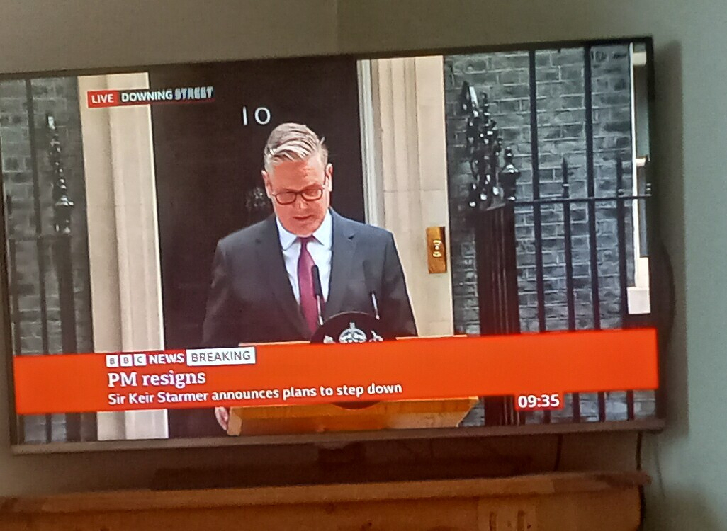 Sir Keir Starmer is seen announcing his plans to step down as Prime Minister outside 10 Downing Street during a live BBC News broadcast.