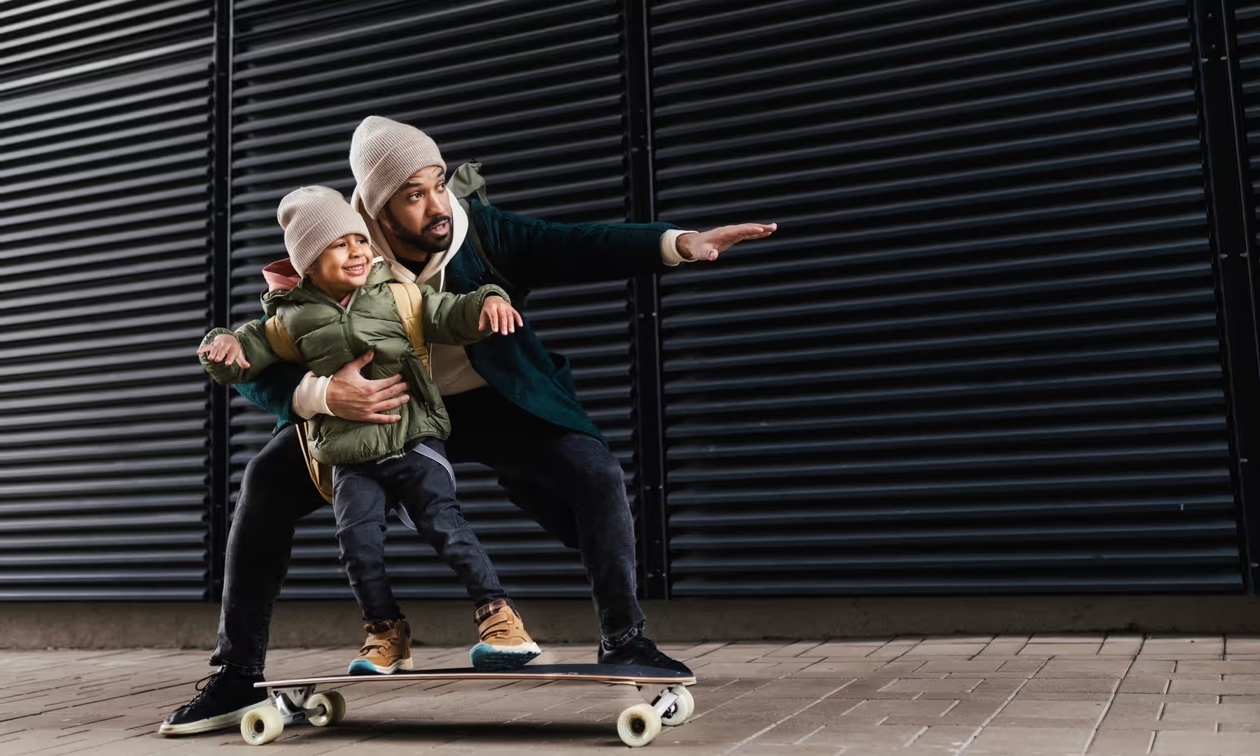 Father teaching his son to skateboard