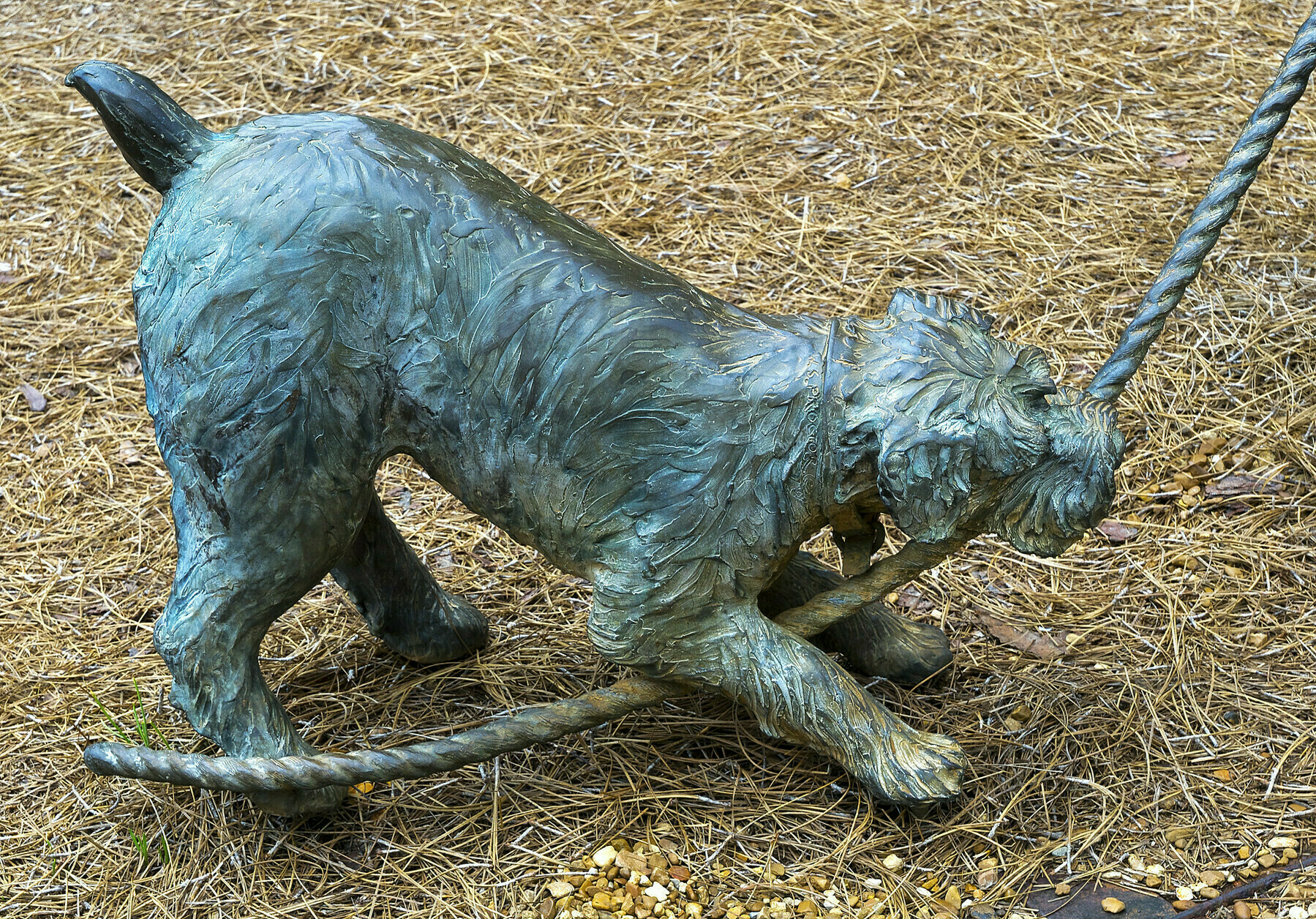 Statue of dog tugging at a rope