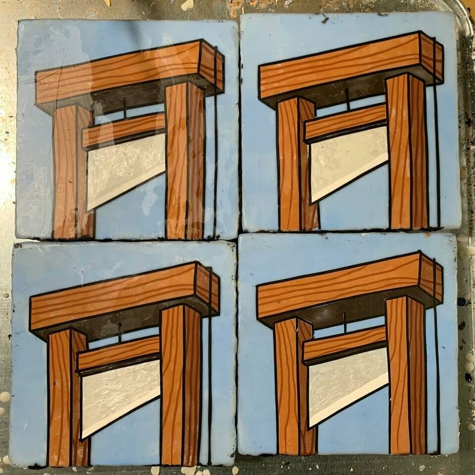 Four square tiles, each depicting a guillotine, against a consistent light blue background.
