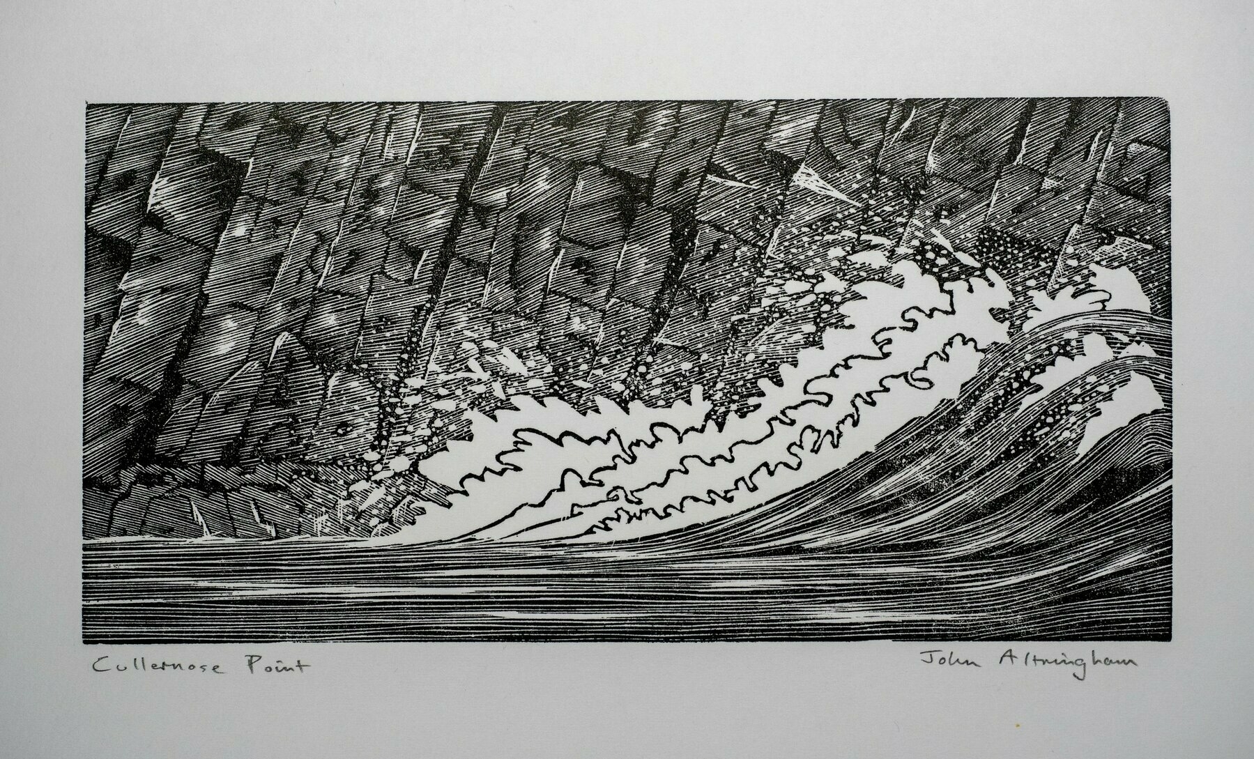 A black and white artwork depicts a dynamic and textured wave, giving off an impressionist or woodblock print style, signed at the bottom by the artist.