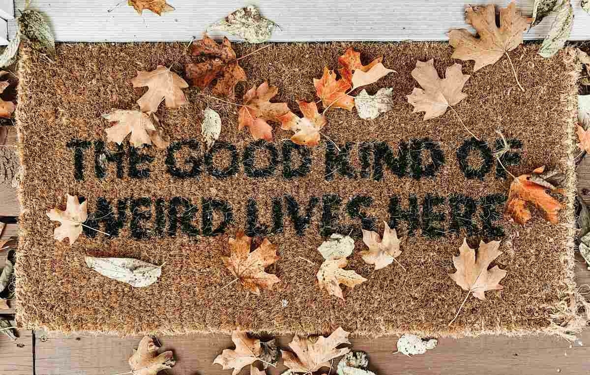 Doormat covered in leaves saying THE GOOD KIND OF WEIRD LIVES HERE