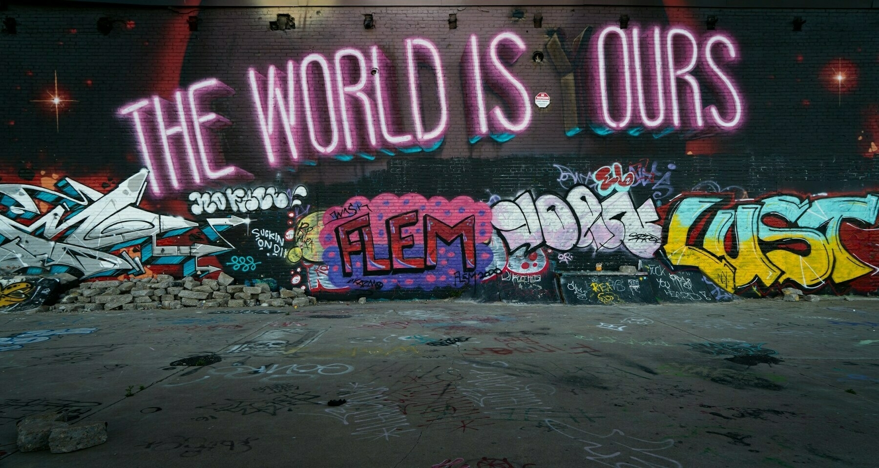 Graffiti saying THE WORLD IS OURS