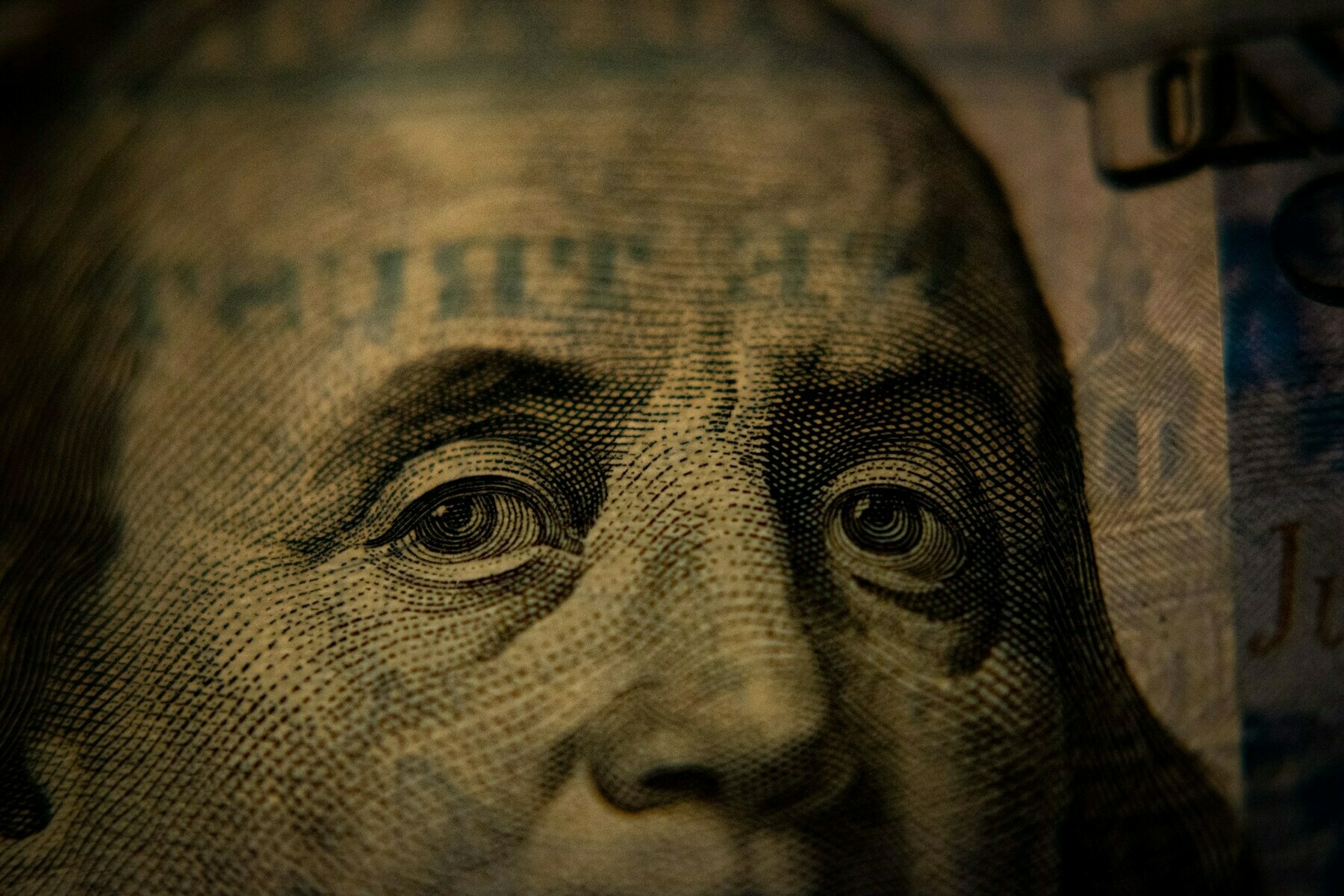 A closeup of a US hundred dollar bill (Benjamin Franklin side).