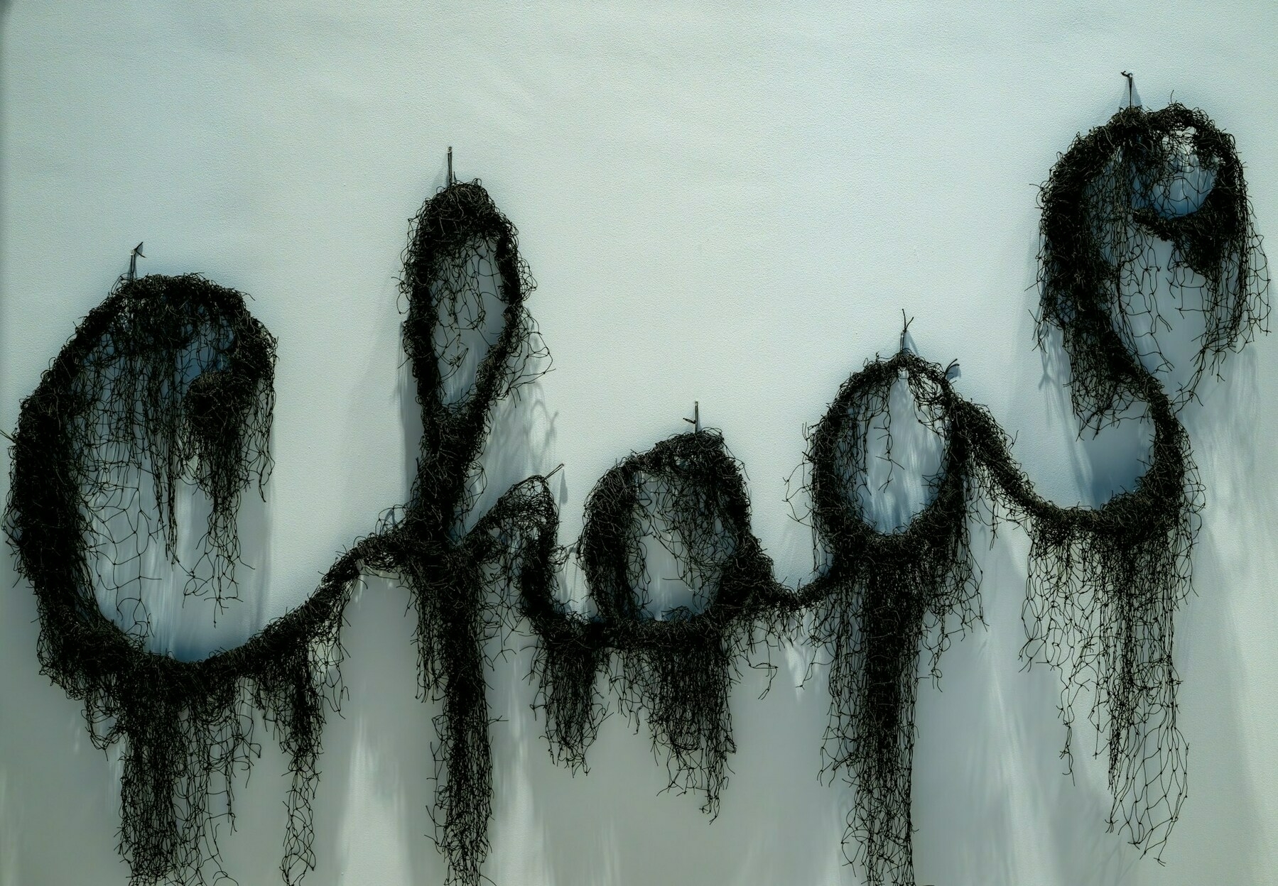 The word 'Chaos' made out of black netting