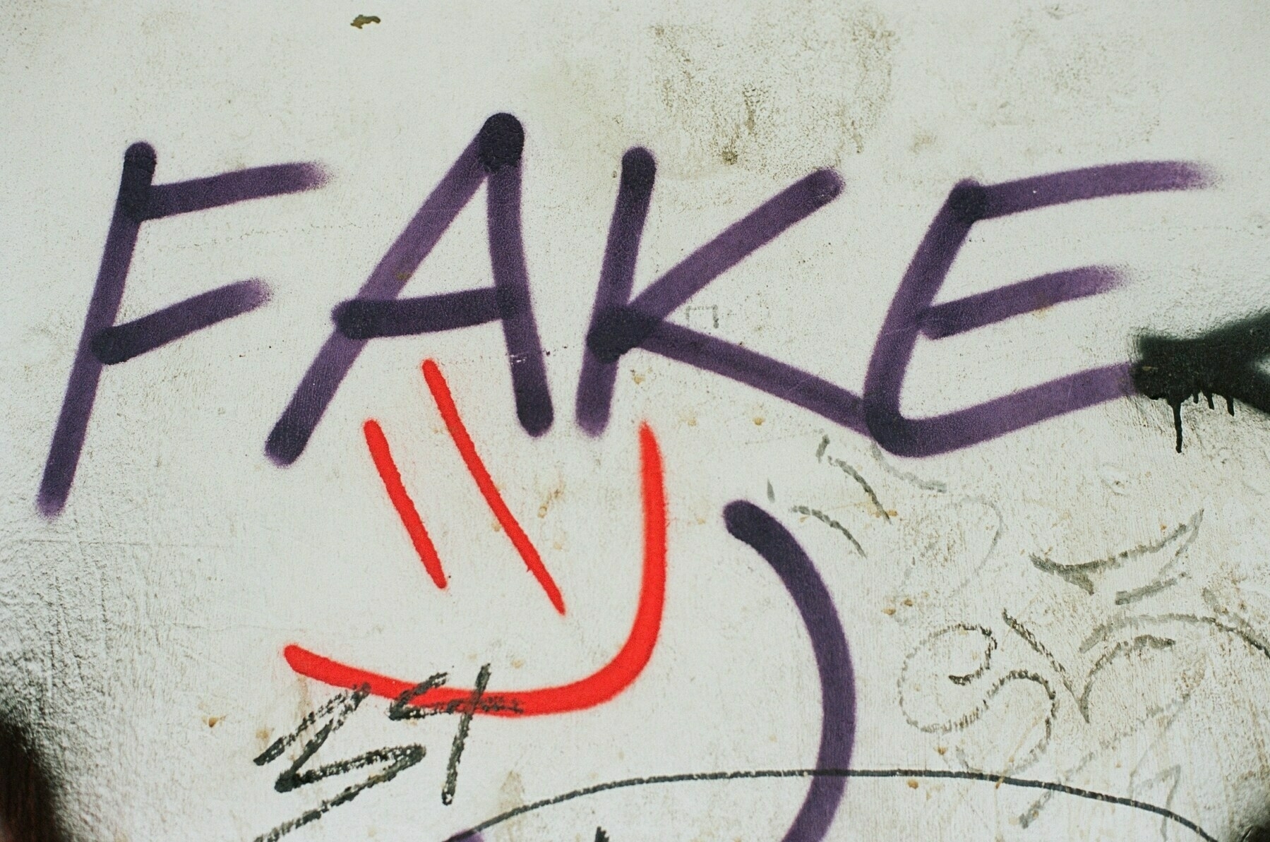 Graffiti saying 'FAKE'