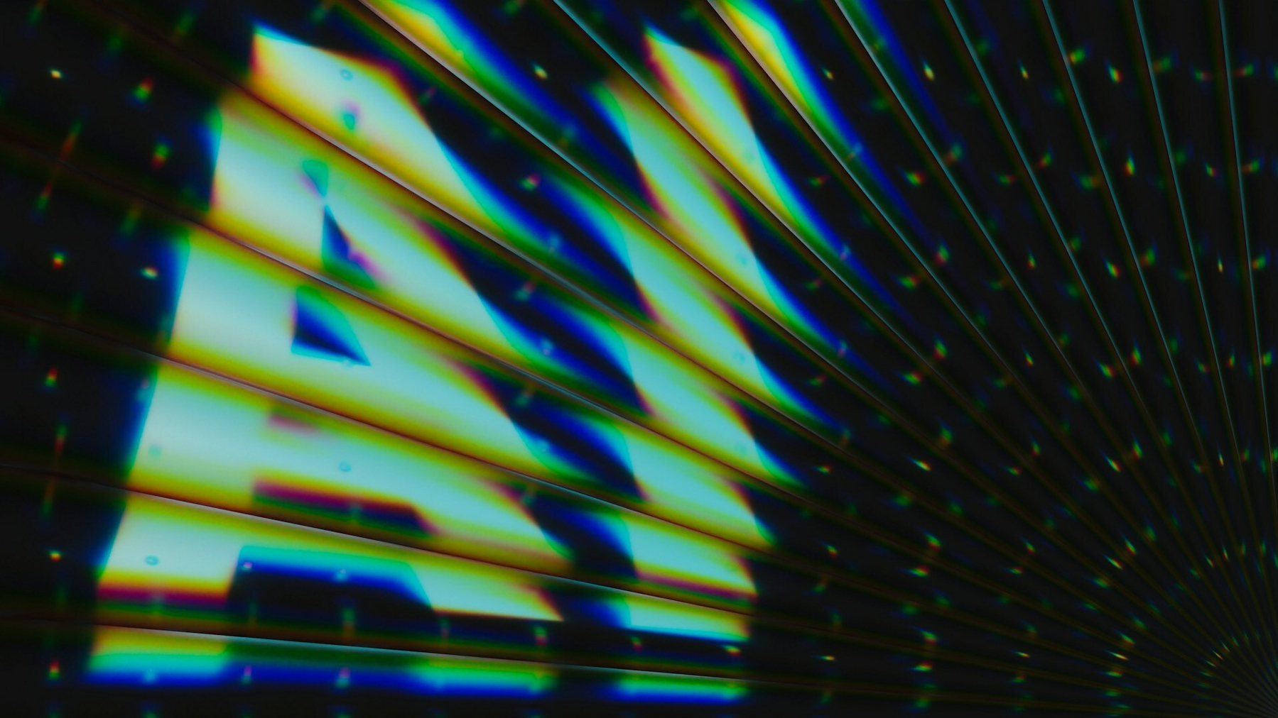 Auto-generated description: A vibrant, abstract depiction of the letters AI is displayed with colorful, wavy lines extending across the image.