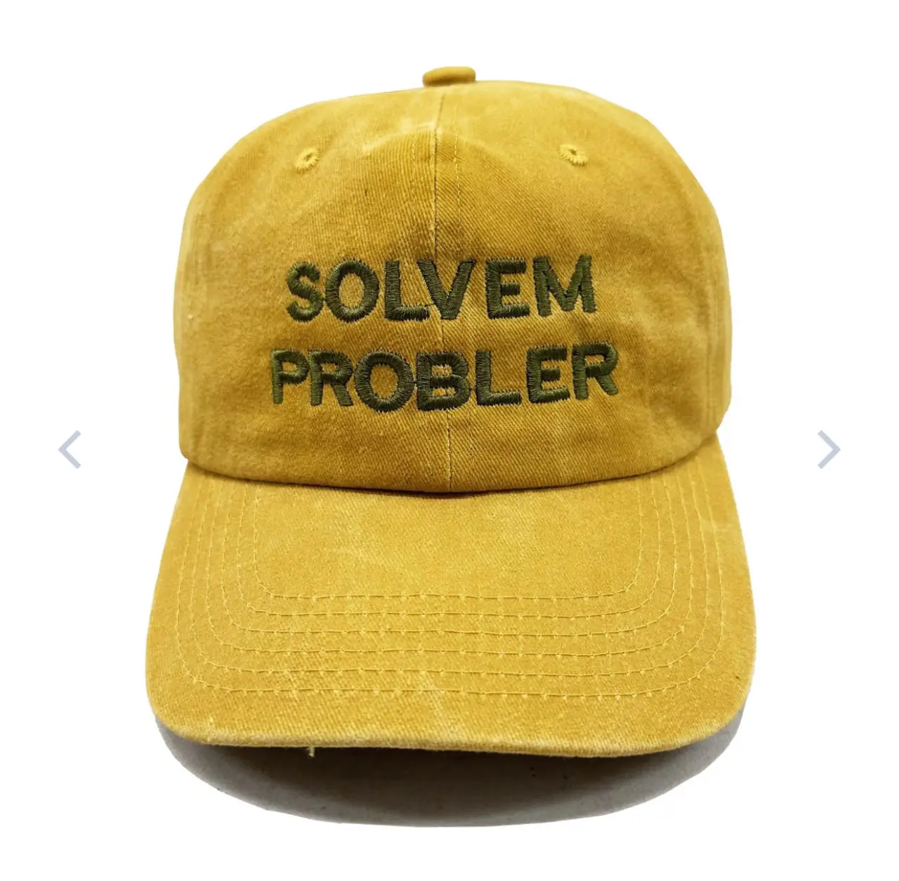 Auto-generated description: A yellow baseball cap features the misspelled text SOLVEM PROBLER in green embroidery.