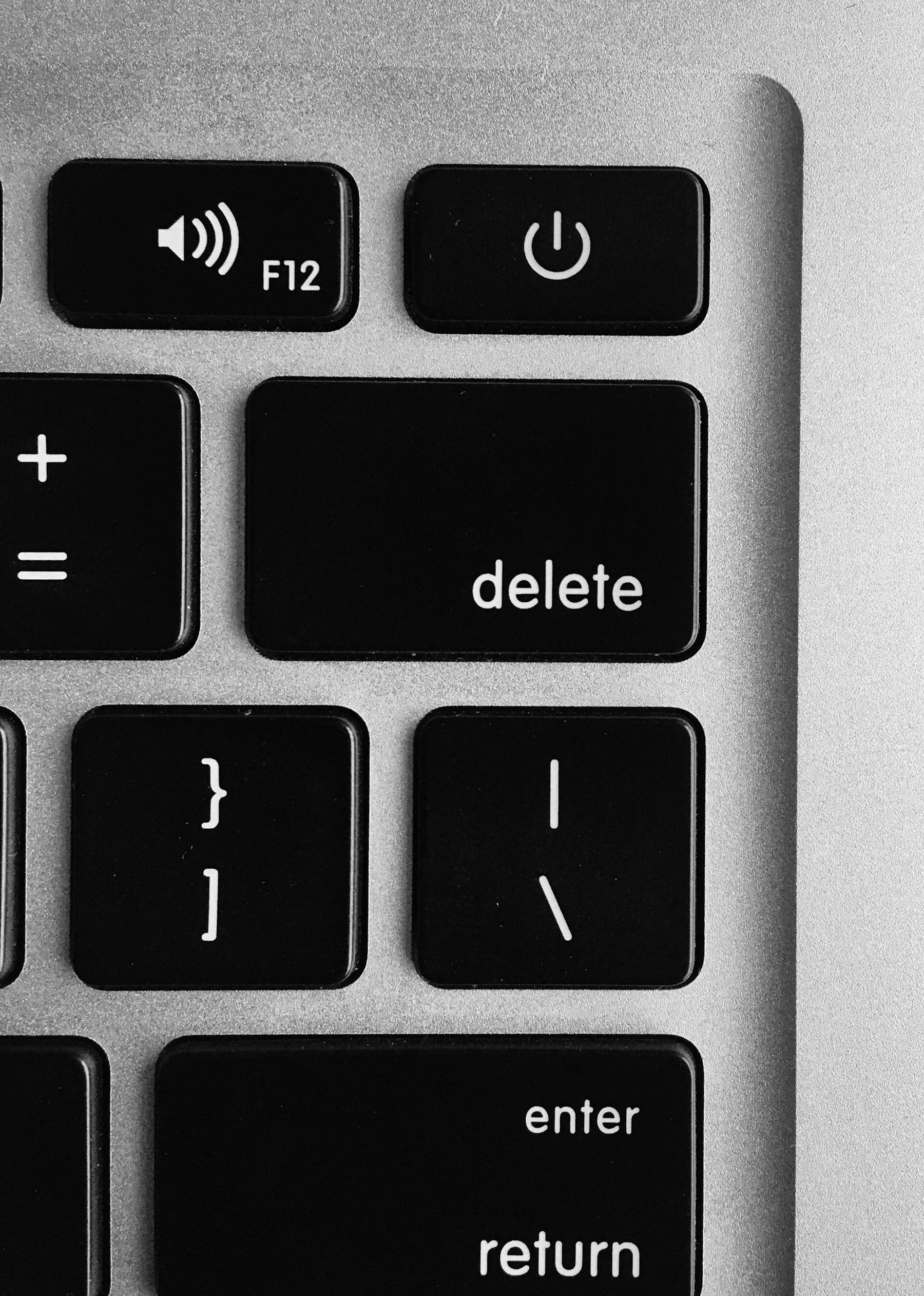 Auto-generated description: A close-up view of a keyboard shows the delete, return, power, and volume control keys.