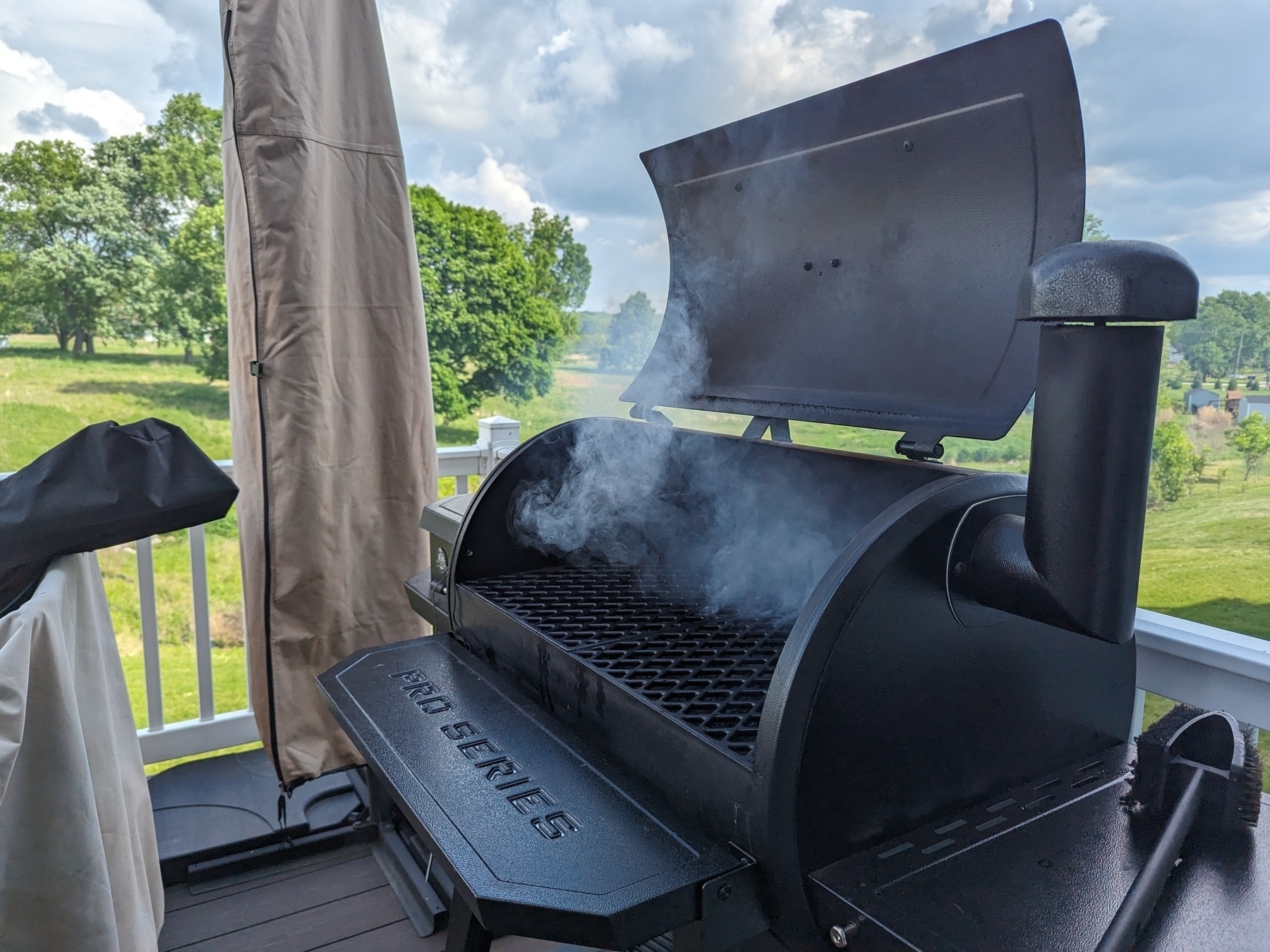 A pit Boss pellet grill with smoke coming out.