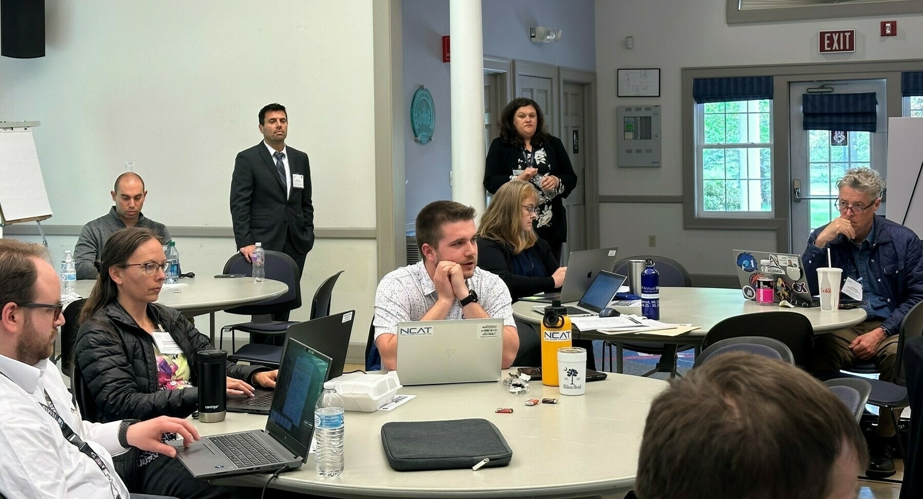 Jake sitting with other nasa agile practitioners in a conference room