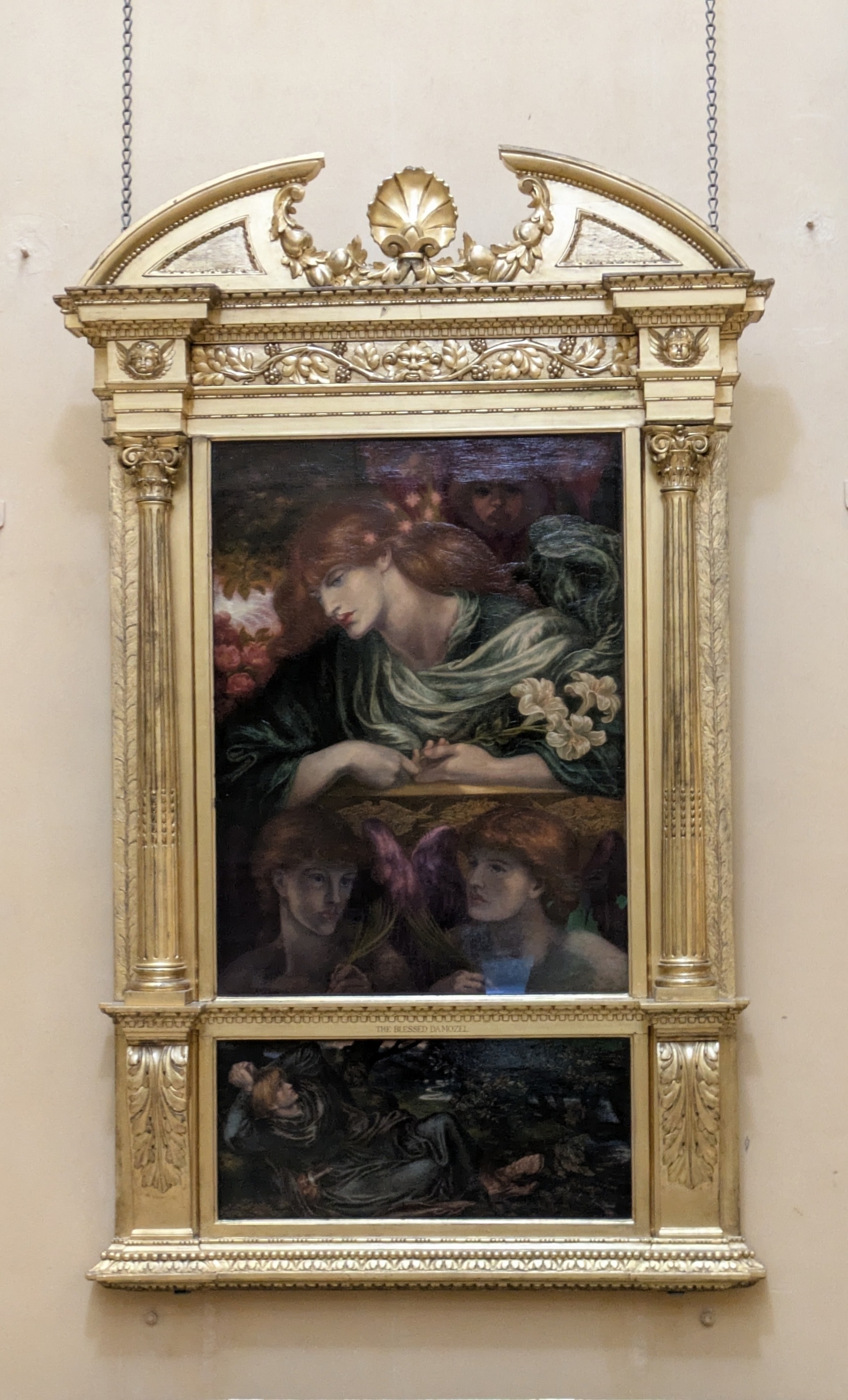 A richly framed artwork depicts a woman with red hair and green drapery surrounded by floral elements, alongside other figures, in a classical style.