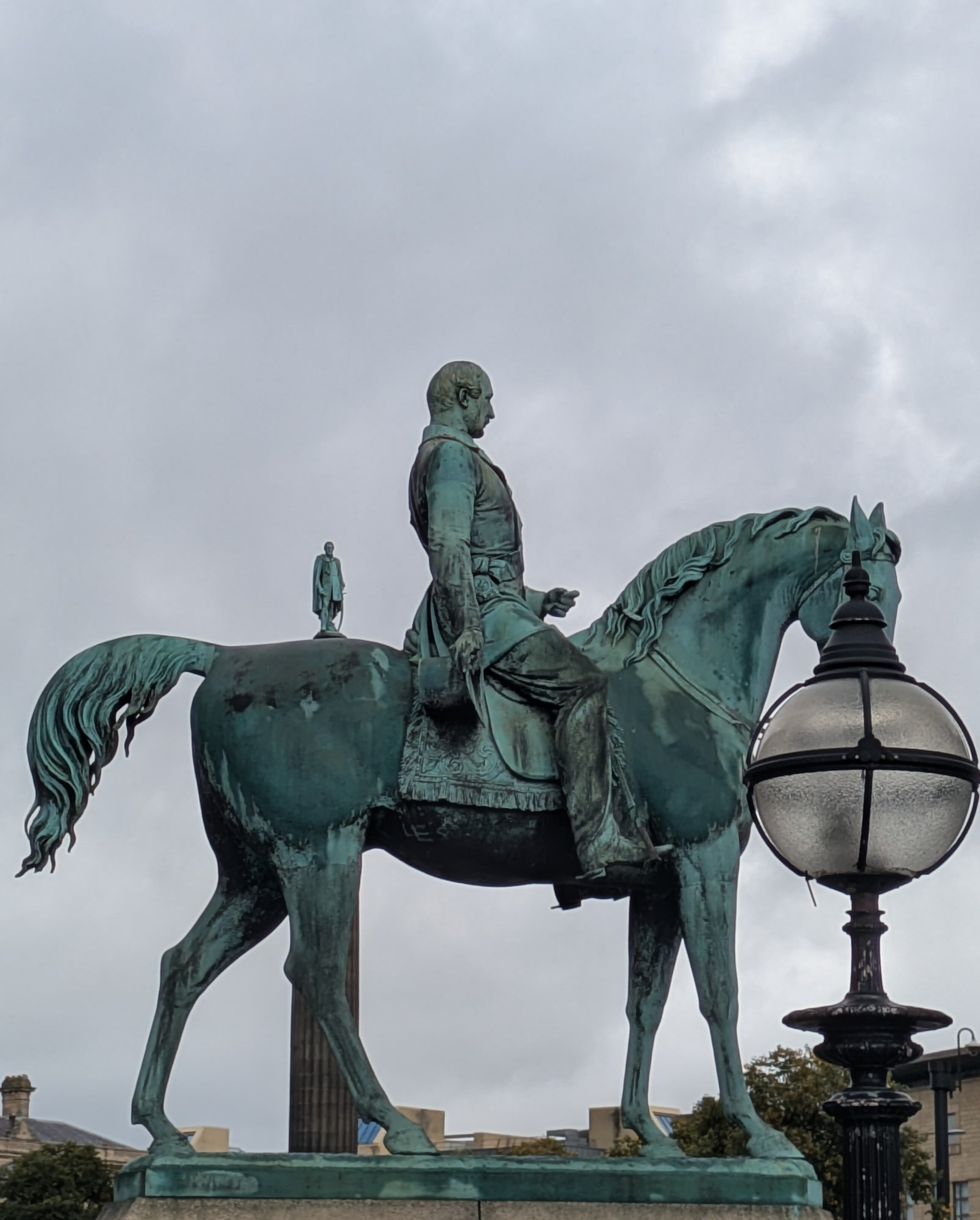 A large equestrian statue features a man on horseback with a smaller statue of a person standing on the horse’s back. Not really. 