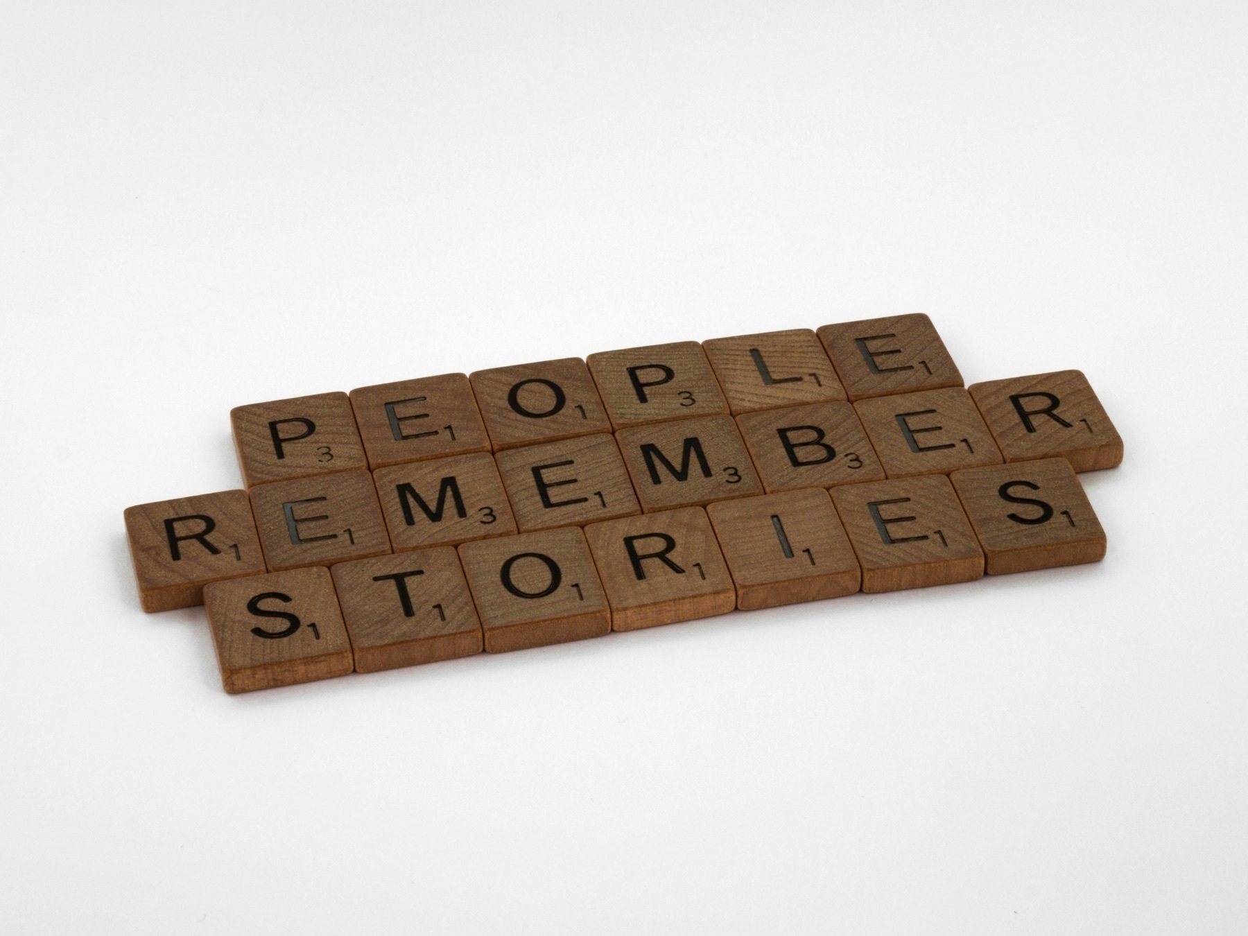 Scrabble tiles that read, “people remember stories.”