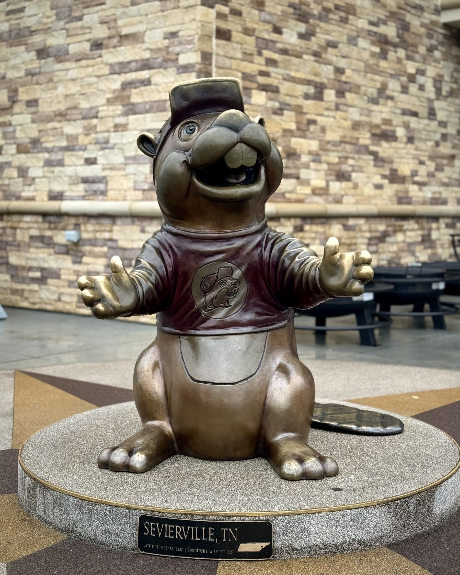 a bronze statue of a stupid beaver mascot with a black reading Sevierville, TN