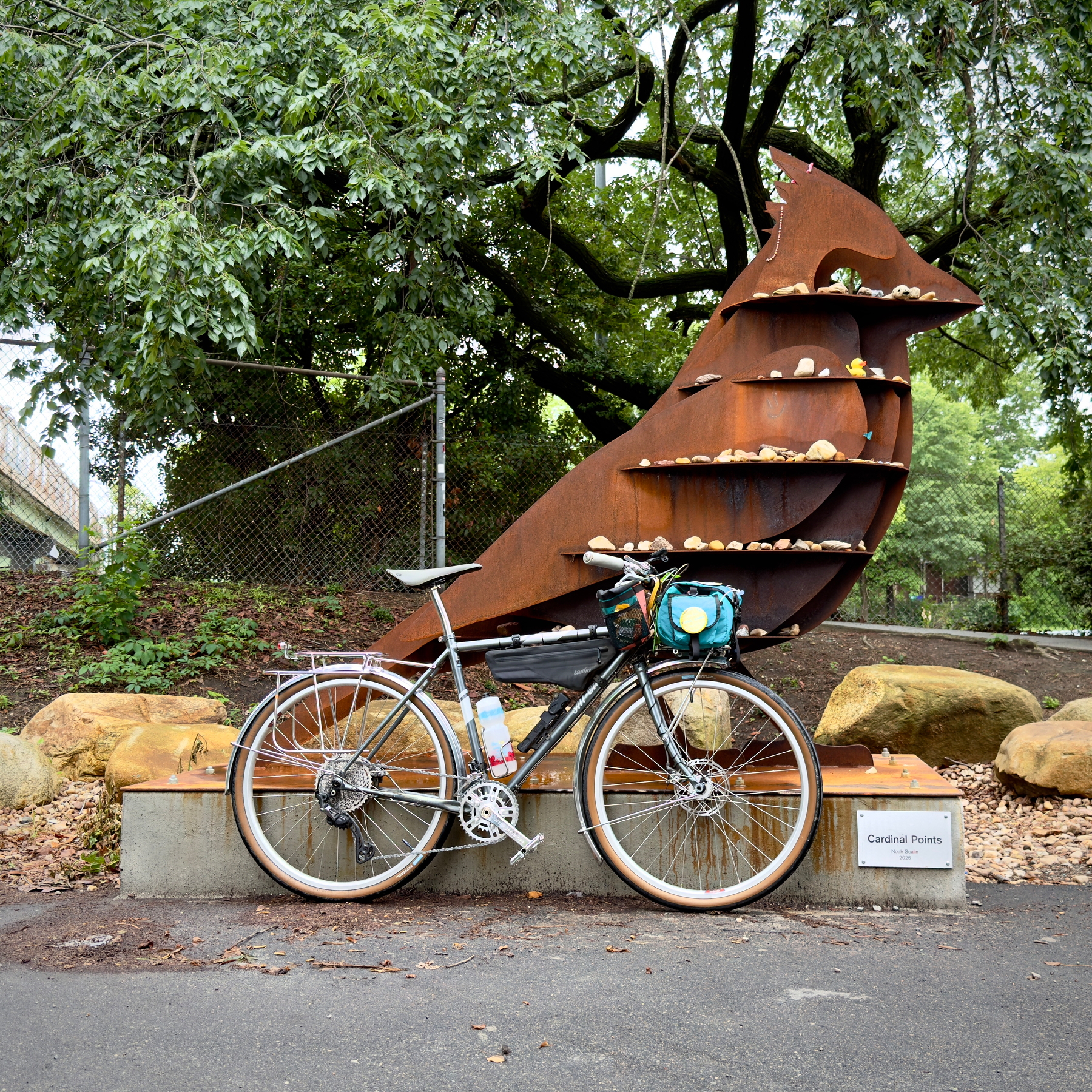 My All-City Space Horse bike in front of a steel cardinal sculpture that is taller than a person 