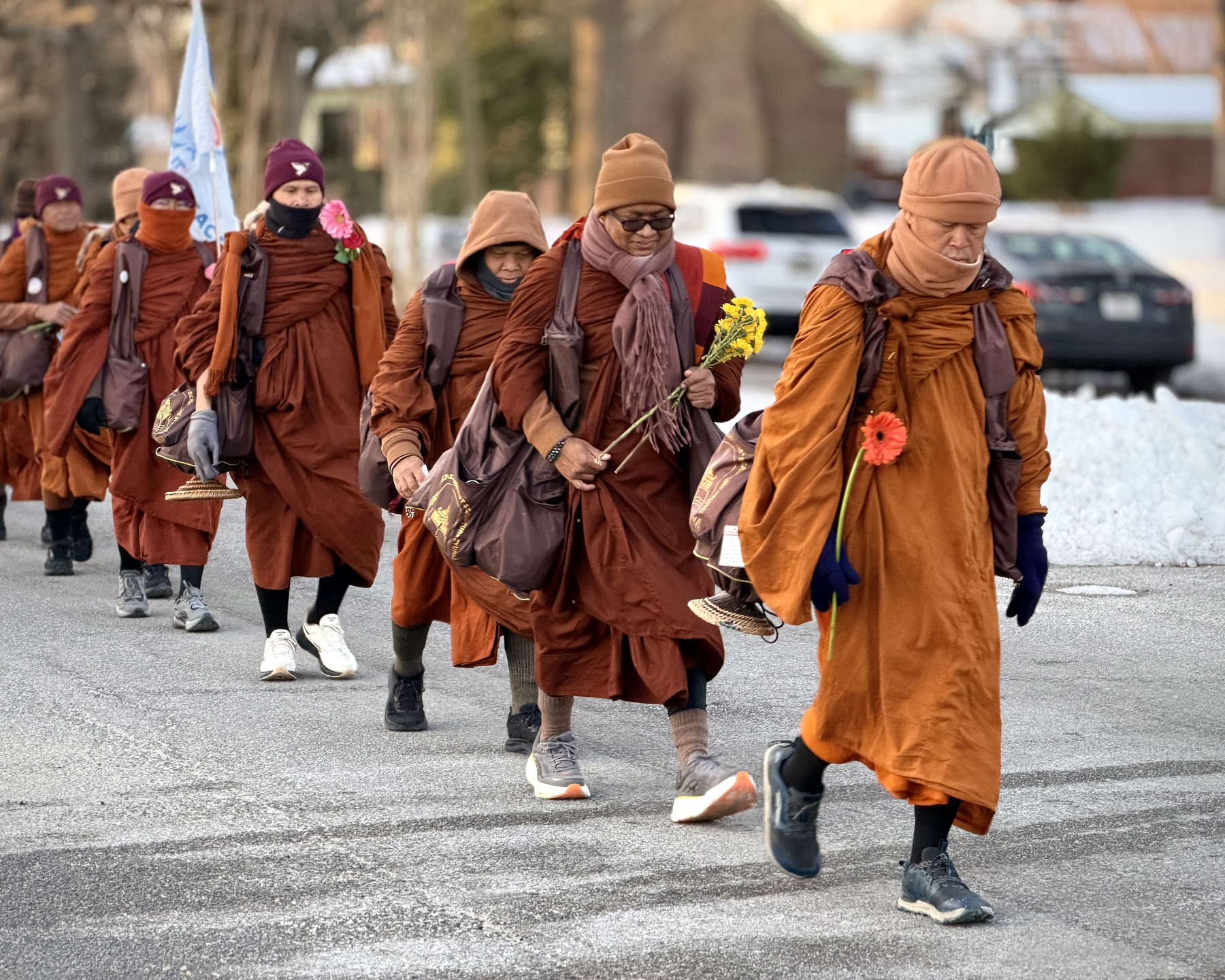 Monks of the Dhammacetiya walk up Brook Road in Richmond as part of their walk for peace