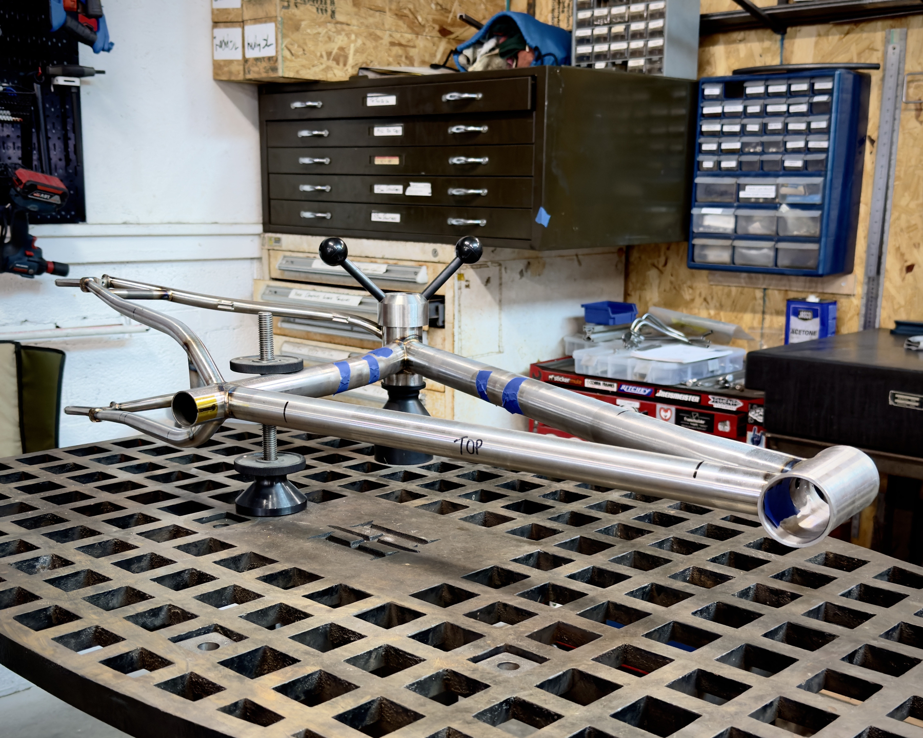 bike frame clamped down to a table for frame straightening