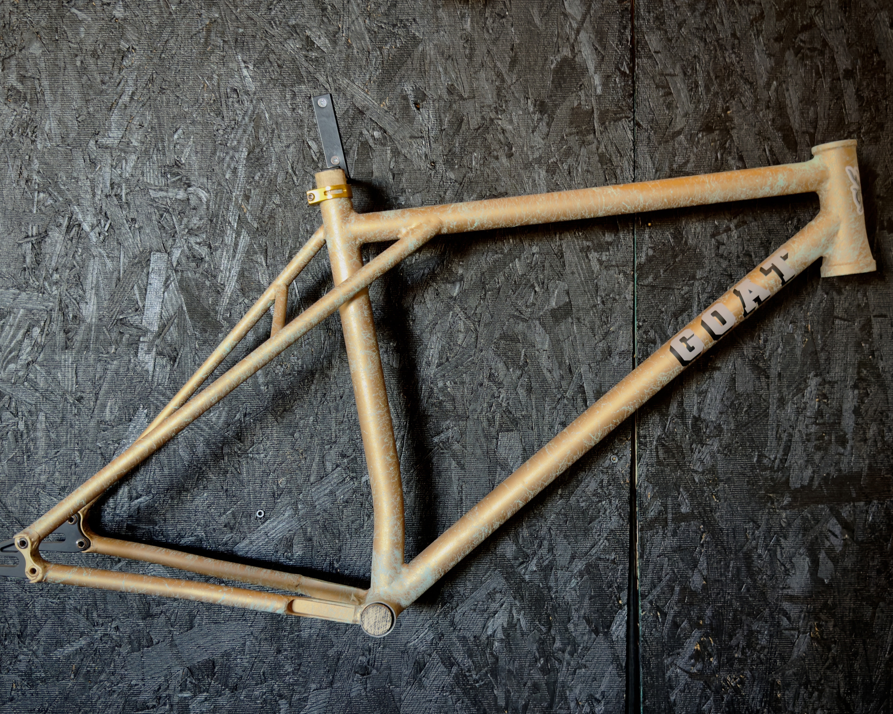 a G.O.A.T> track frame with a really cool paintn job of drizzle-style paint over a solid base coat