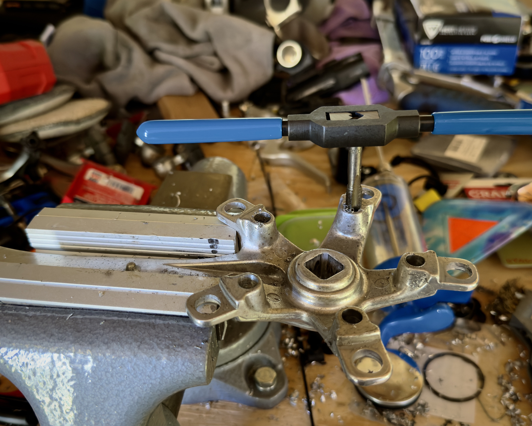 a tap and handle stick out of a hole in a drive-side crank arm for a bicycle
