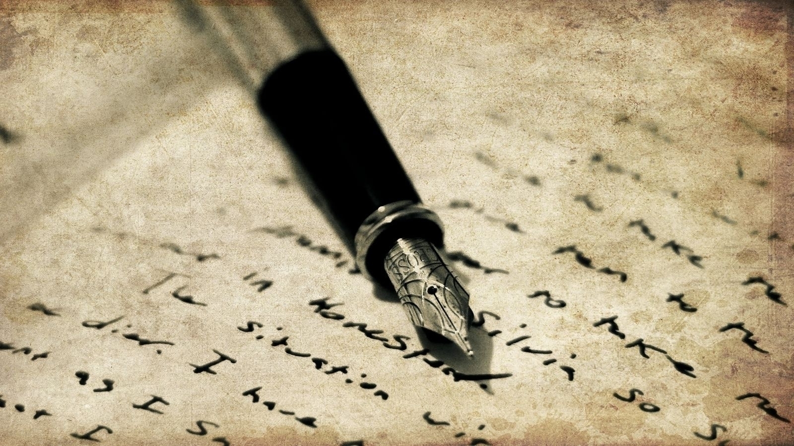 Auto-generated description: A fountain pen lies on a piece of paper filled with handwritten text.