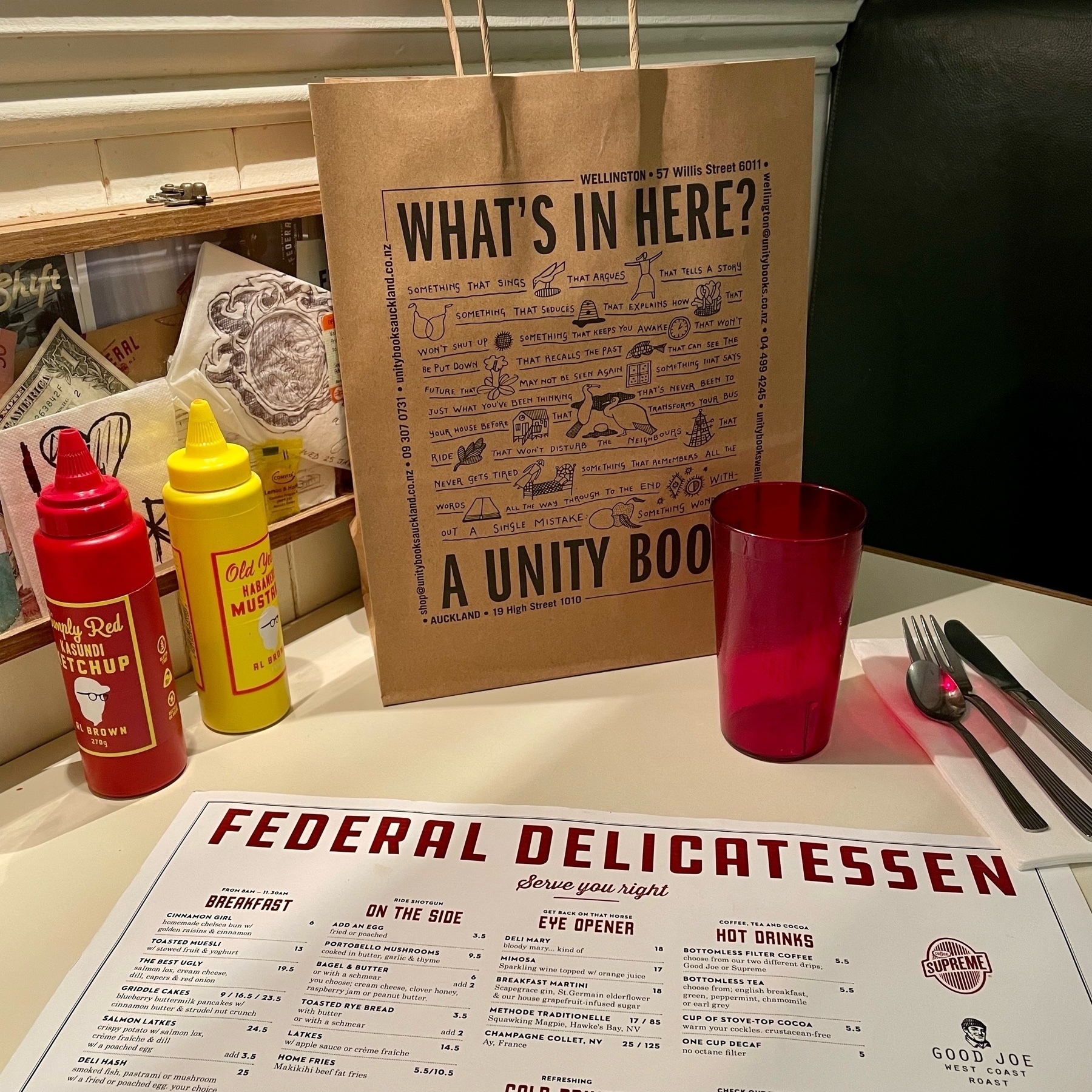 bag of books from Unity in a booth at Federal Deli