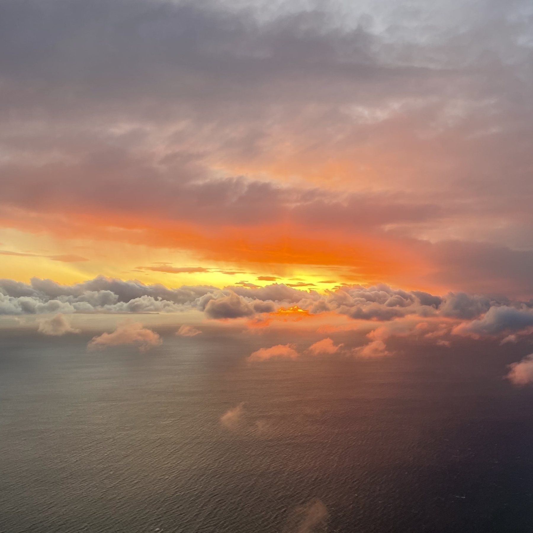 Sunset and clouds from the air - deep orange and bright yellow on the clouds
