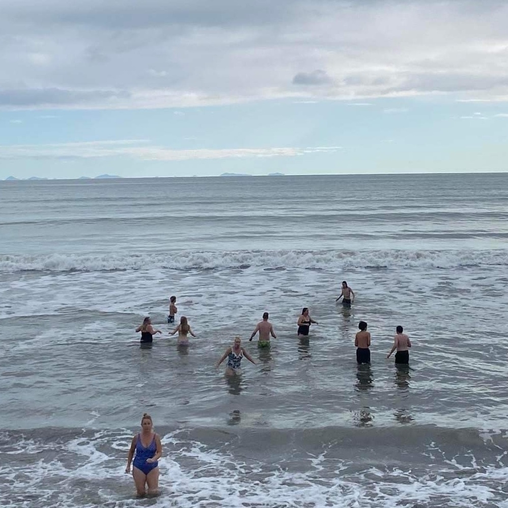 Group of mad people swimming in the cold sea