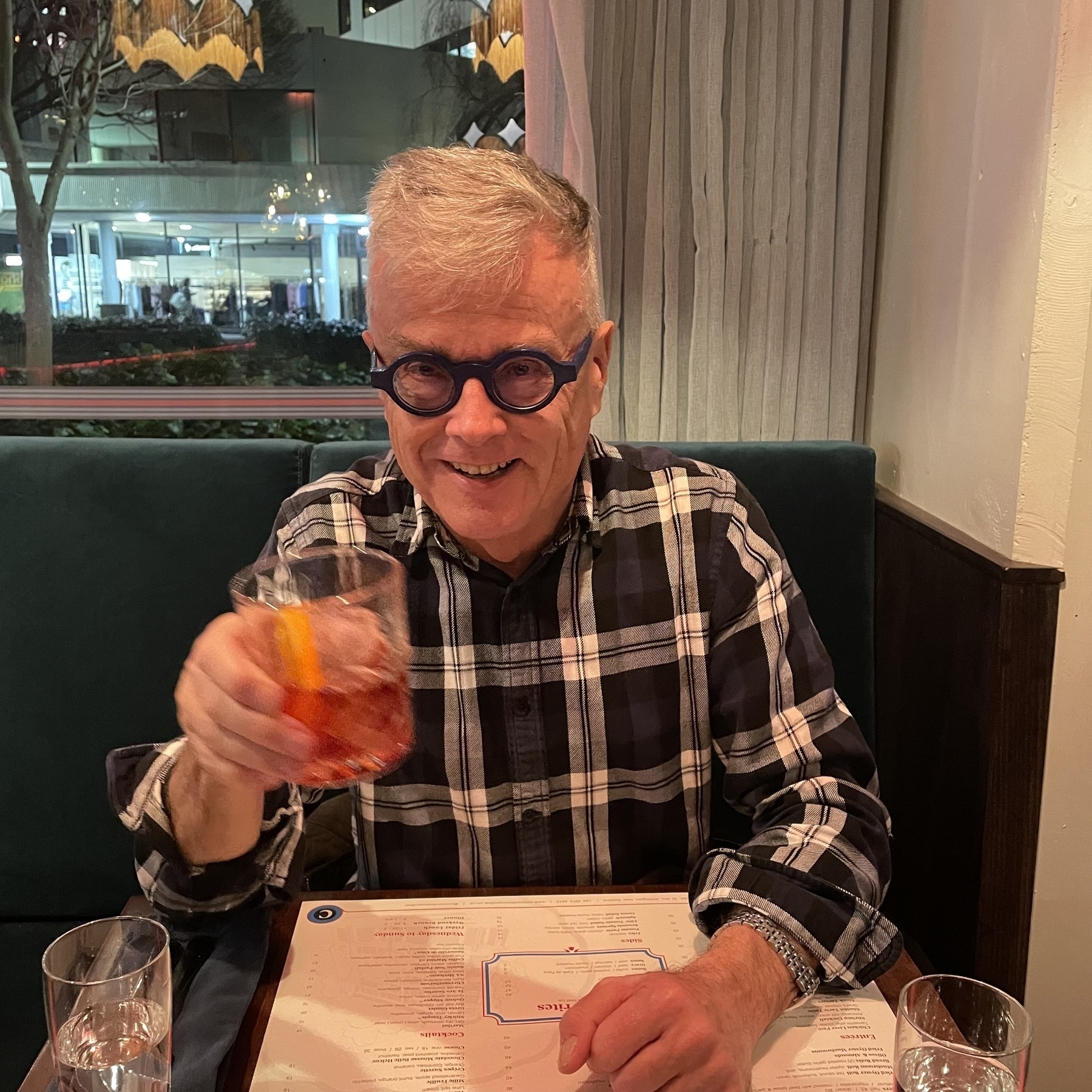 Bill holding up a negroni at Concord Restaurant, Wellington