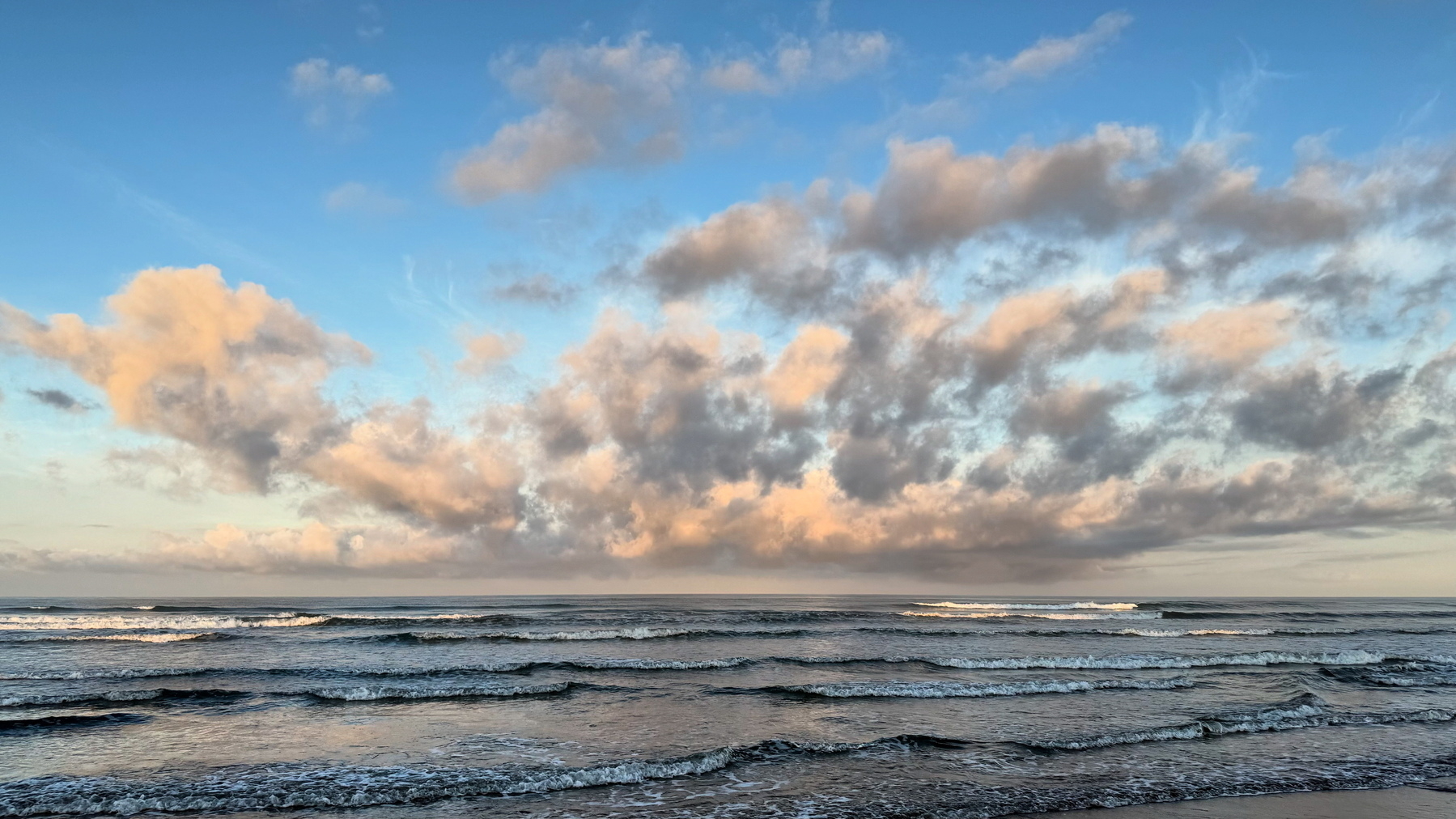 Rose-tipped clouds over the sea. 