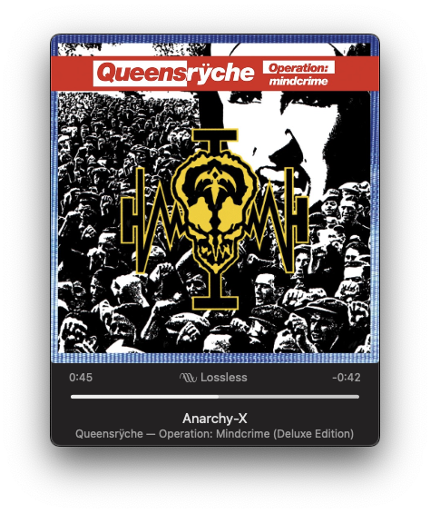 An album cover for Operation: Mindcrime by Queensrÿche is displayed, featuring a stylized emblem over a background of a crowd.