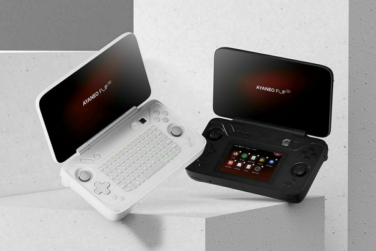 An image of two AYANEO Flip gaming devices, one white with a keyboard and the other black with a second display..