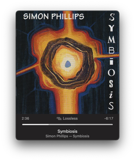 An album cover featuring abstract artwork with a central circular design is shown, along with a music player displaying Symbiosis by Simon Phillips.