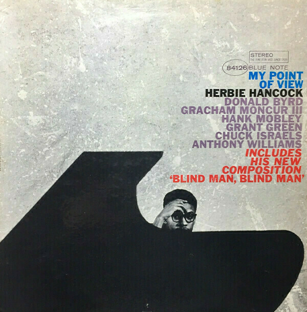 Album cover for “My Point of View” by Herbie Hancock. The design features a minimalist black and white background with a large black shape resembling a piano. A small figure of a man wearing glasses and holding his hand to his face is partially visible. The album title and artist’s name are prominently displayed in colorful text, along with the names of other musicians.