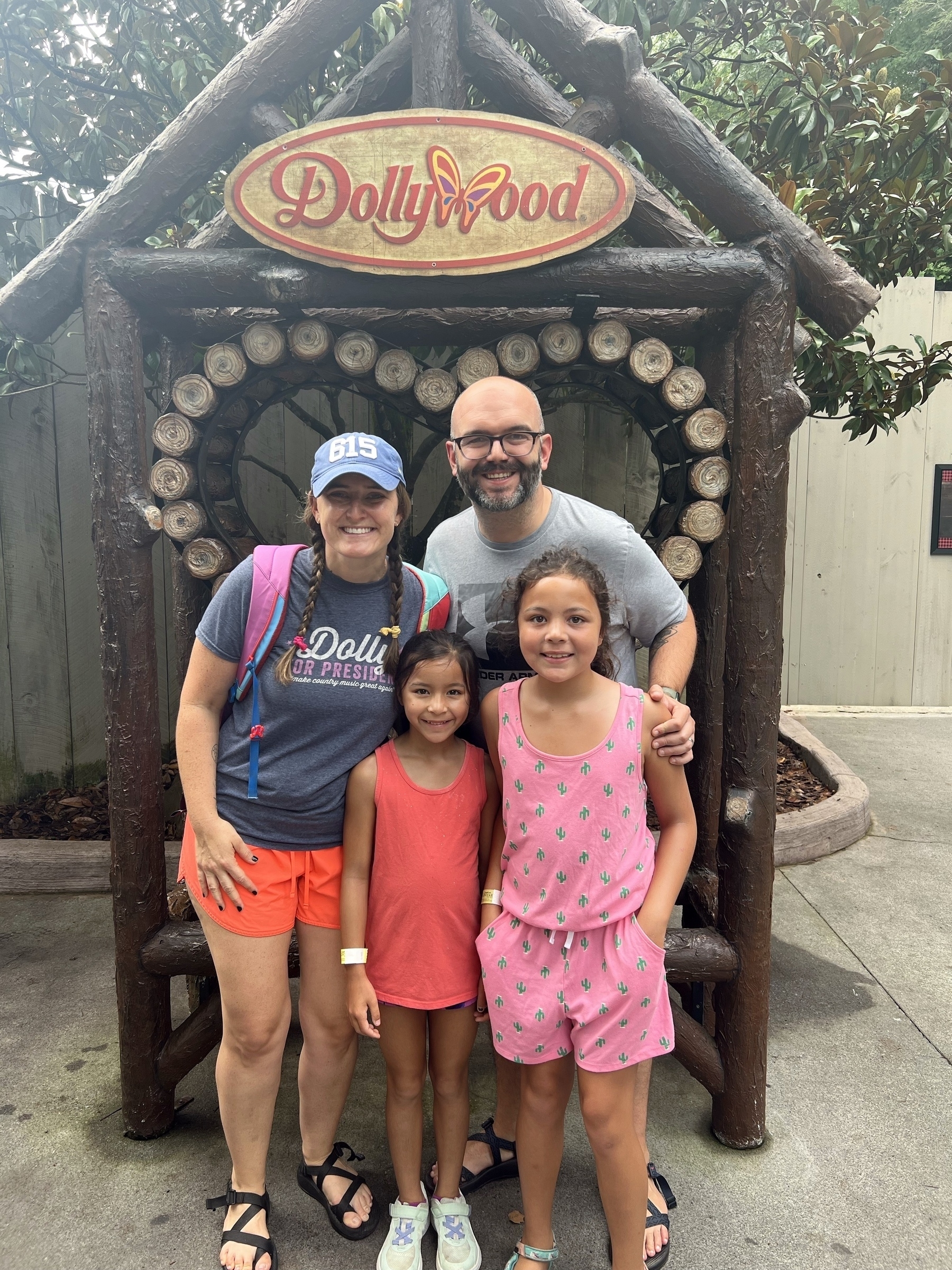 Family in front of wooden structure with Dollywood sign