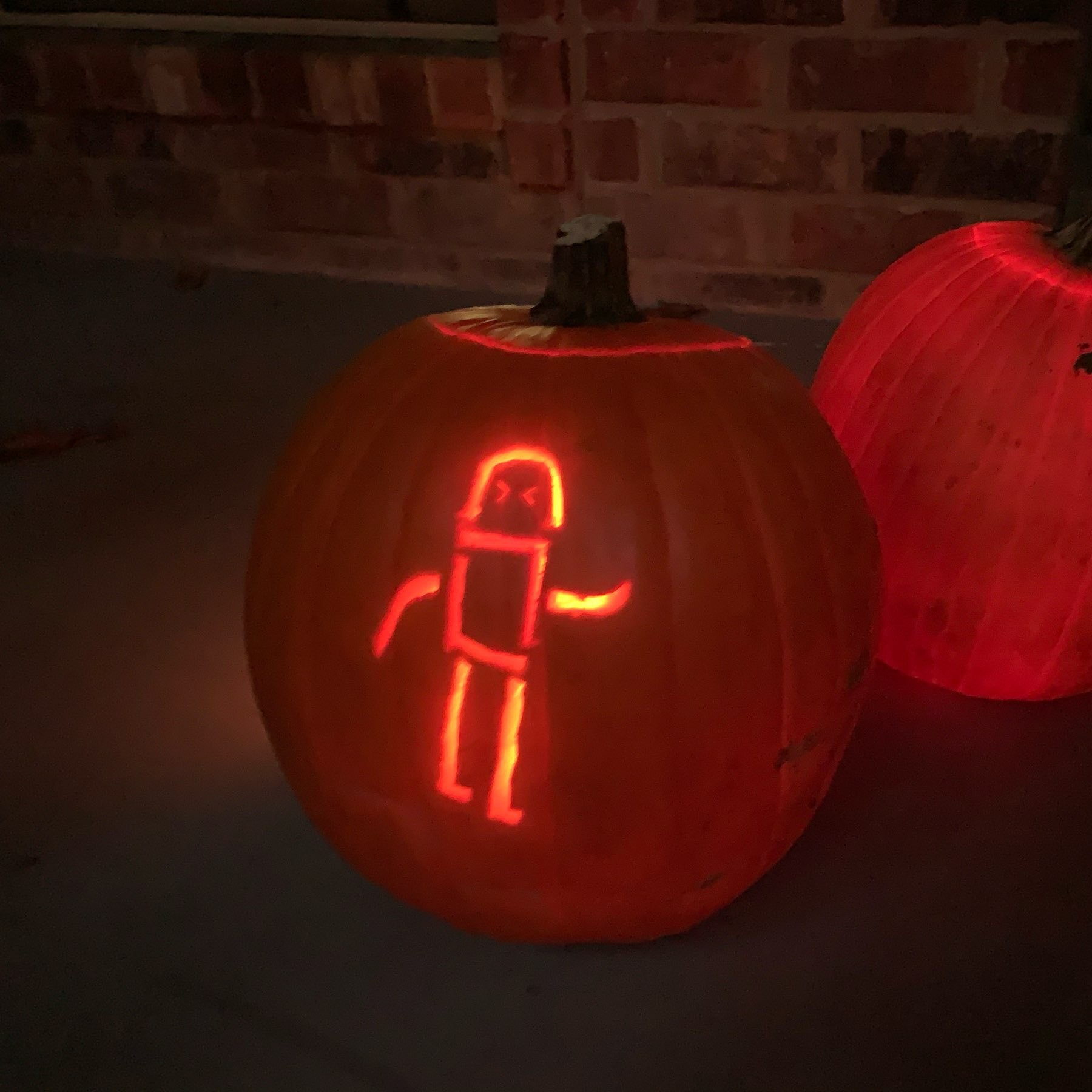 Robot carved into a lighted pumpkin