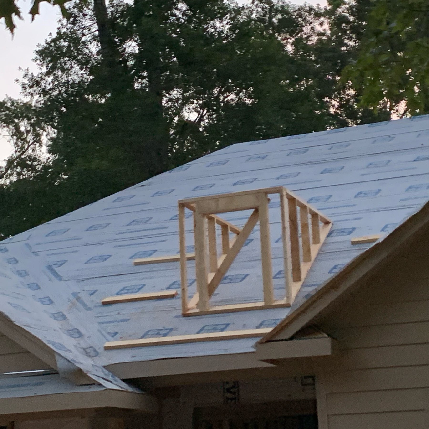 Fake window framed on roof of new home construction