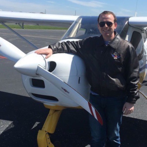 Chet standing with a Light Sport airplane